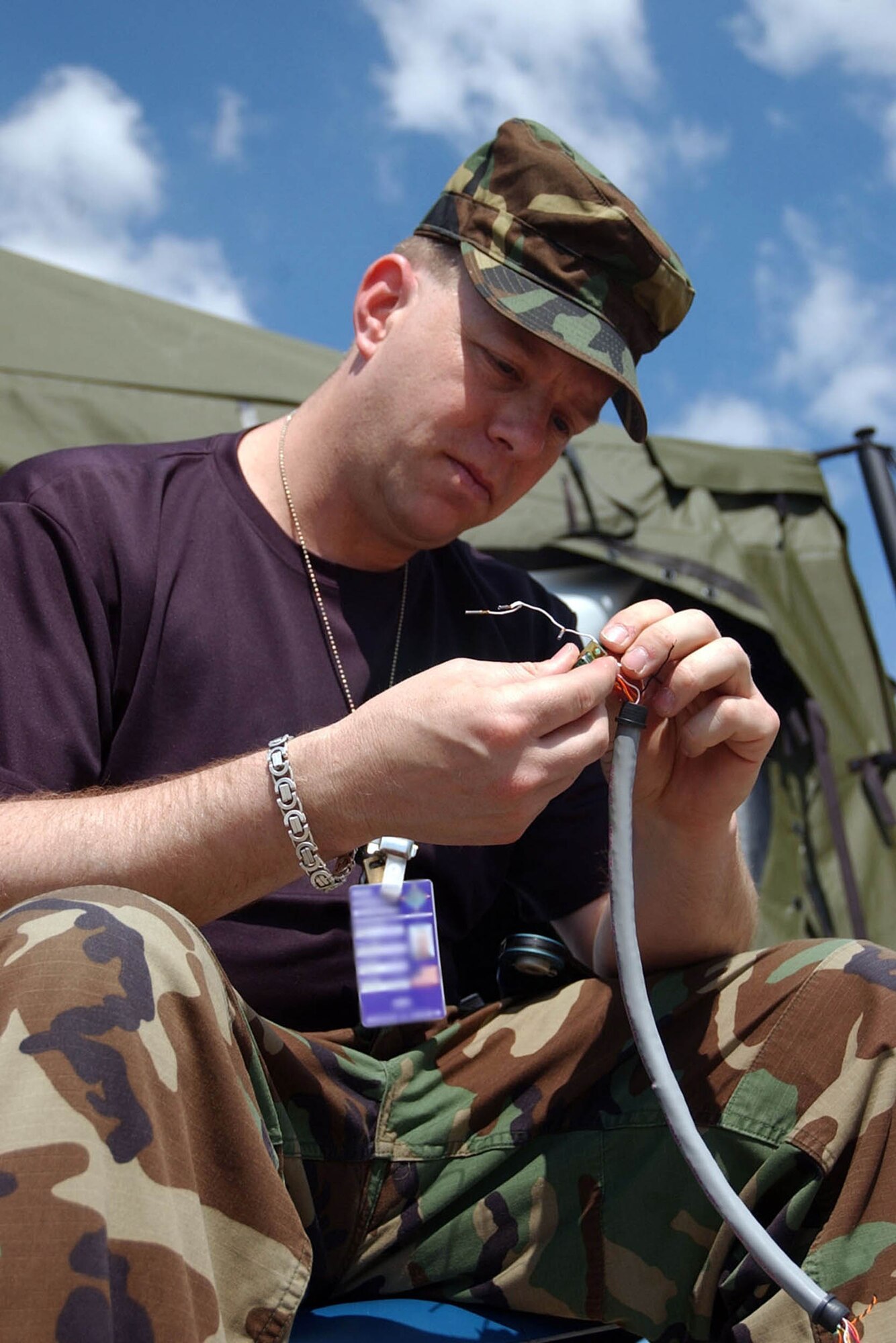 U.S. Air Force Tech. Sgt. Stephen Adams, an infrastructure technician with 1st Combat Communications Squadron, Tech. Sgt. Stephen Adams, an infrastructure technician with 1st Combat Communications Squadron, splices wires during Combined Endeavor 2008 in Baumholder, Germany May 5, 2008. More than 35 participating nations use the exercise to plan, prepare and practice using a full range of communications, equipment, policies and procedures prior to deploying for NATO missions and emerging, real-world crisis situations. (U.S. Air Force photo by Staff Sgt. Brian Hill)( Released)