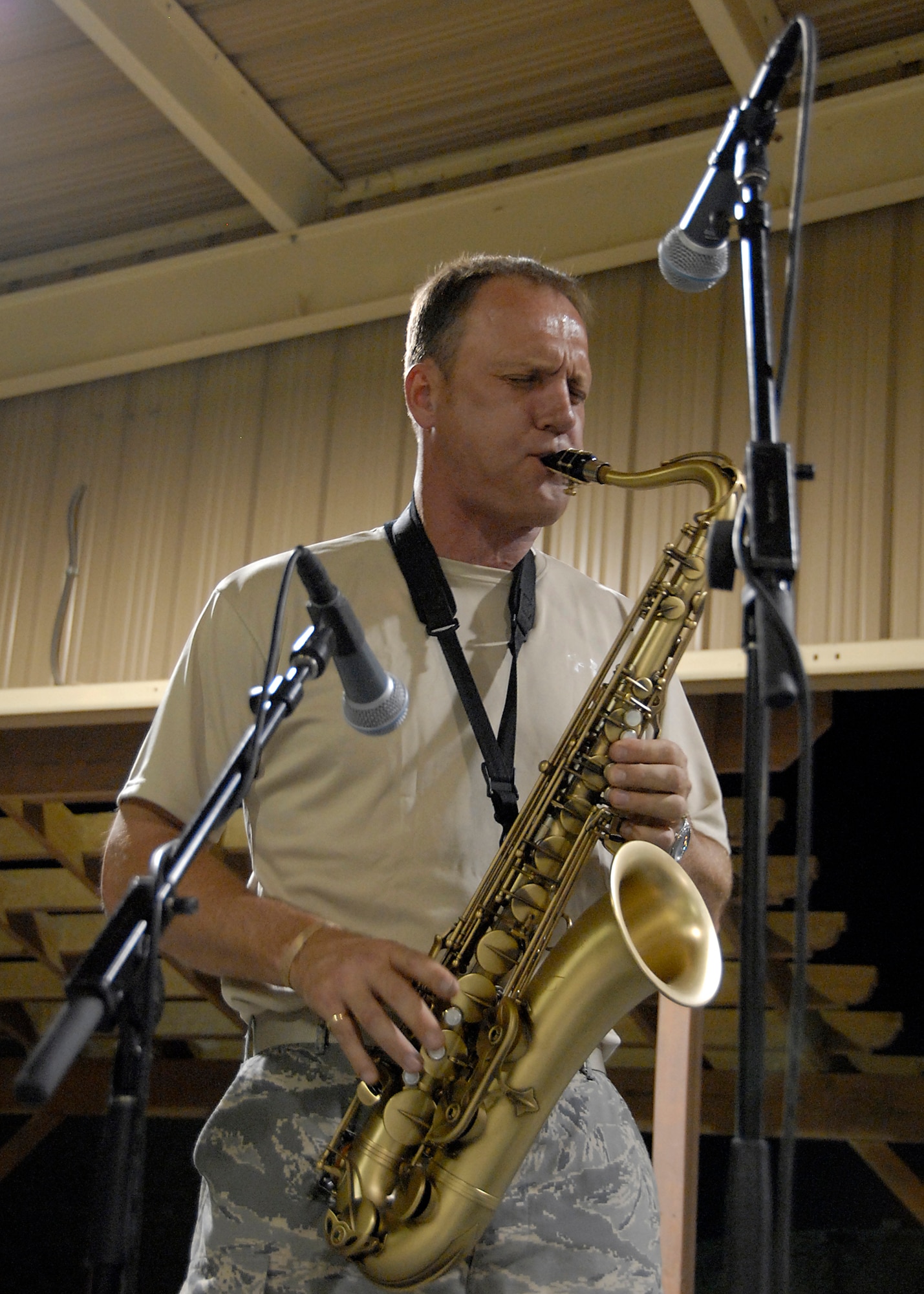 SOUTHWEST ASIA -- Master Sgt. Daniel Weber, a saxophonist with the U.S. Air Force Central Command Band called Falcon digs down deep to express himself in front of audience of U.S. and coalition forces during a May 15, 2008 performance at an air base in the Persian Gulf Region. The Falcon Band recently kicked off a 60-day tour throughout Southwest Asia and the Horn of Africa to positively promote troop morale, diplomacy and outreach to host nation communities. (U.S. Air Force photo/Tech. Sgt. Michael O'Connor)