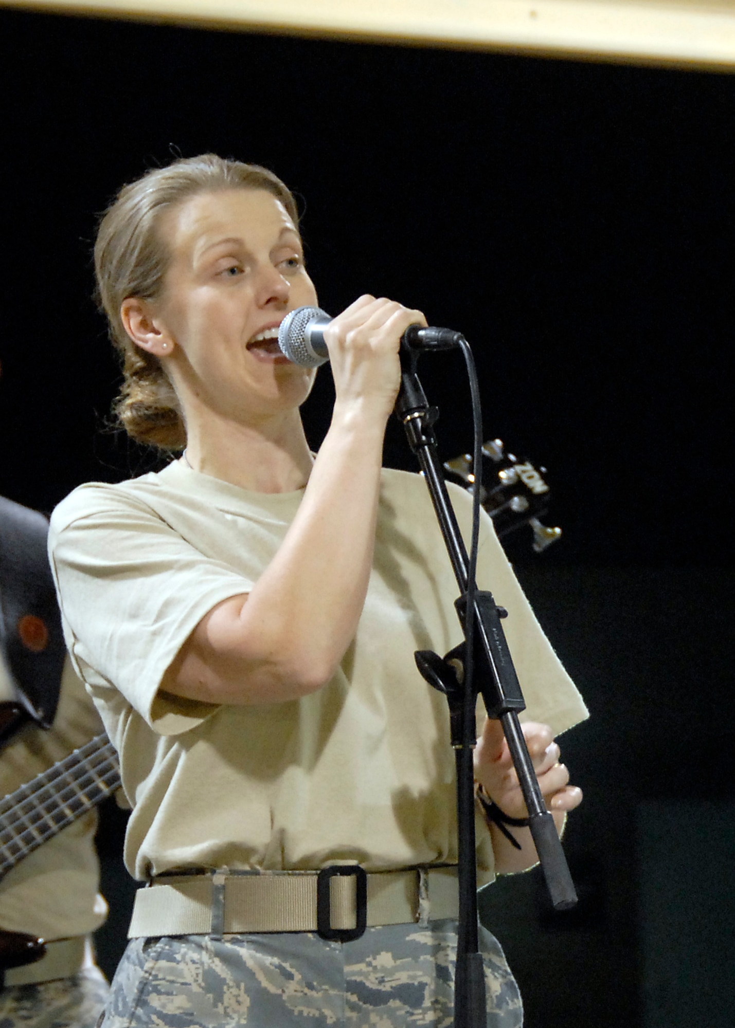 SOUTHWEST ASIA -- Staff Sgt. Krista Joyce, a vocalist with the U.S. Air Force Central Command Band called Falcon sings her way into the hearts of U.S. and coalition forces during a May 15, 2008 performance at an air base in the Persian Gulf Region.  The Falcon Band recently kicked off a 60-day tour throughout Southwest Asia and the Horn of Africa to positively promote troop morale, diplomacy and outreach to host nation communities. (U.S. Air Force photo/Tech. Sgt. Michael O'Connor)