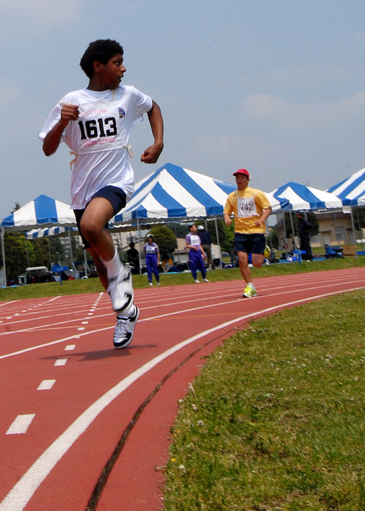 YOKOTA AIR BASE, Japan -- Althetes run to victory May 17 during Special Olympics games held here May 17 and 18.  Yokota hosts Special Olympics annually, fostering growth and camaraderie among U.S. and Japanese participants and volunteers from both communities. (U.S. Air Force photo by Senior Airman Laszlo Babocsi)