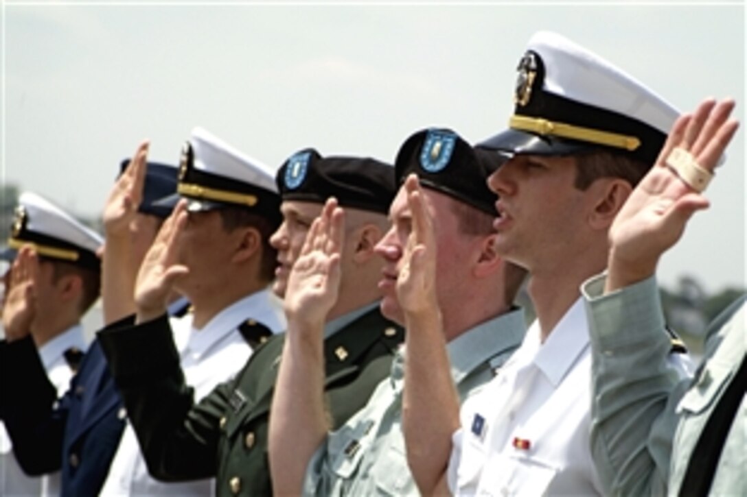 Eastern Virginia Medical School graduates take an oath of office led by Retired U.S. Navy Rear Adm. Philip Geib during a re-commissioning ceremony aboard the battleship USS Wisconsin, Norfolk, VA., May 15, 2008. The students, members of the U.S. Navy, Army and Air Force, advanced from ensign/second lieutenant to lieutenant/captain. 