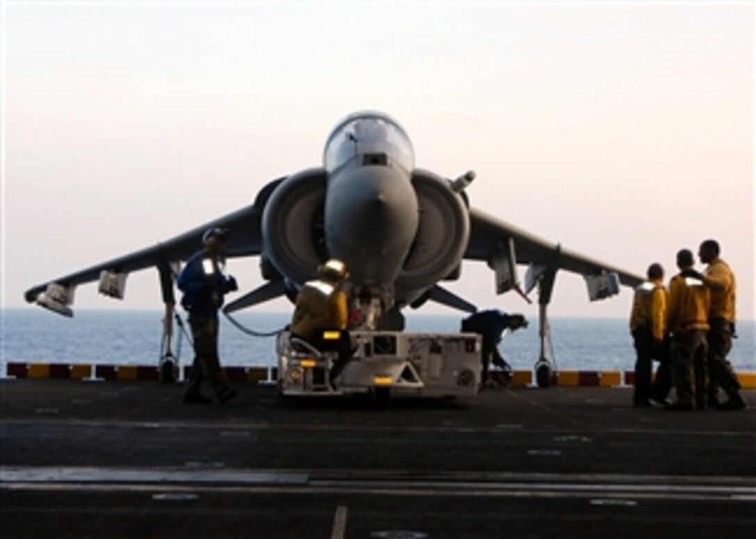 U.S. Navy Aviation Boatswain's Mate Petty Officer 3rd Class Brandt Krauel and other sailors from the air department direct an AV-8B Harrier aircraft into position on an elevator using a spotting dolly aboard the amphibious assault ship USS Peleliu (LHA 5) while underway in the Pacific Ocean on May 15, 2008.  