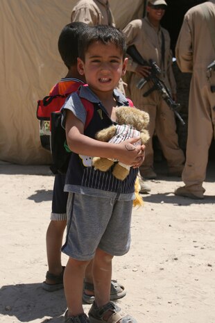 An Iraqi boy holds a teddy bear that he received from Marines and sailors with 2nd Battalion, 3rd Marine Regiment, Regimental Combat Team 1, in Sitcher, Iraq, during a cooperative medical engagement May 21. Approximately 1,000 teddy bears were donated from the Oahu Chapter of Zeta Delta Society in Hawaii, to give to the children of Iraq. The children received the bears after being seen by doctors.