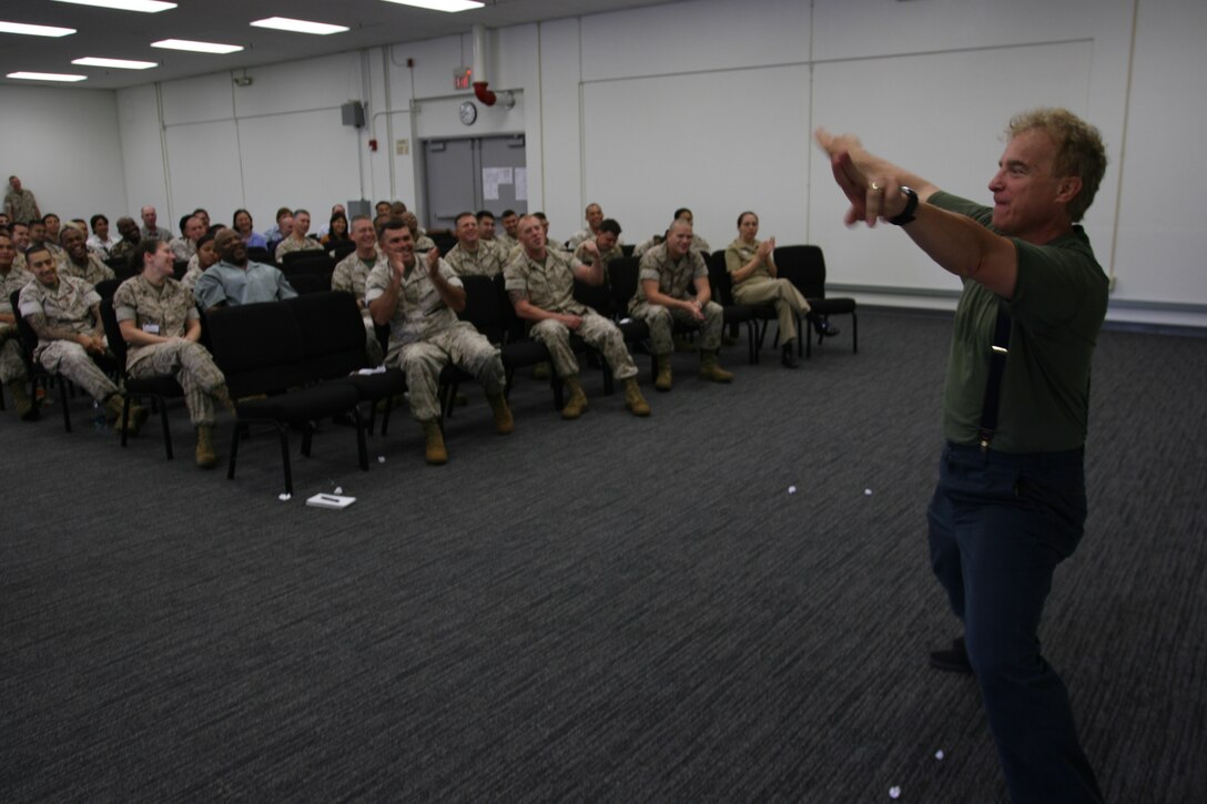 Steve Verret gives love to the crowd during the Stevie Springer Show. The show was a skit given to service members and civilians who attended a driving safety brief May 22 at the Marine Forces Pacific Headquarters Building, Camp H M Smith. Verret is a comedian and traffic safety specialist.