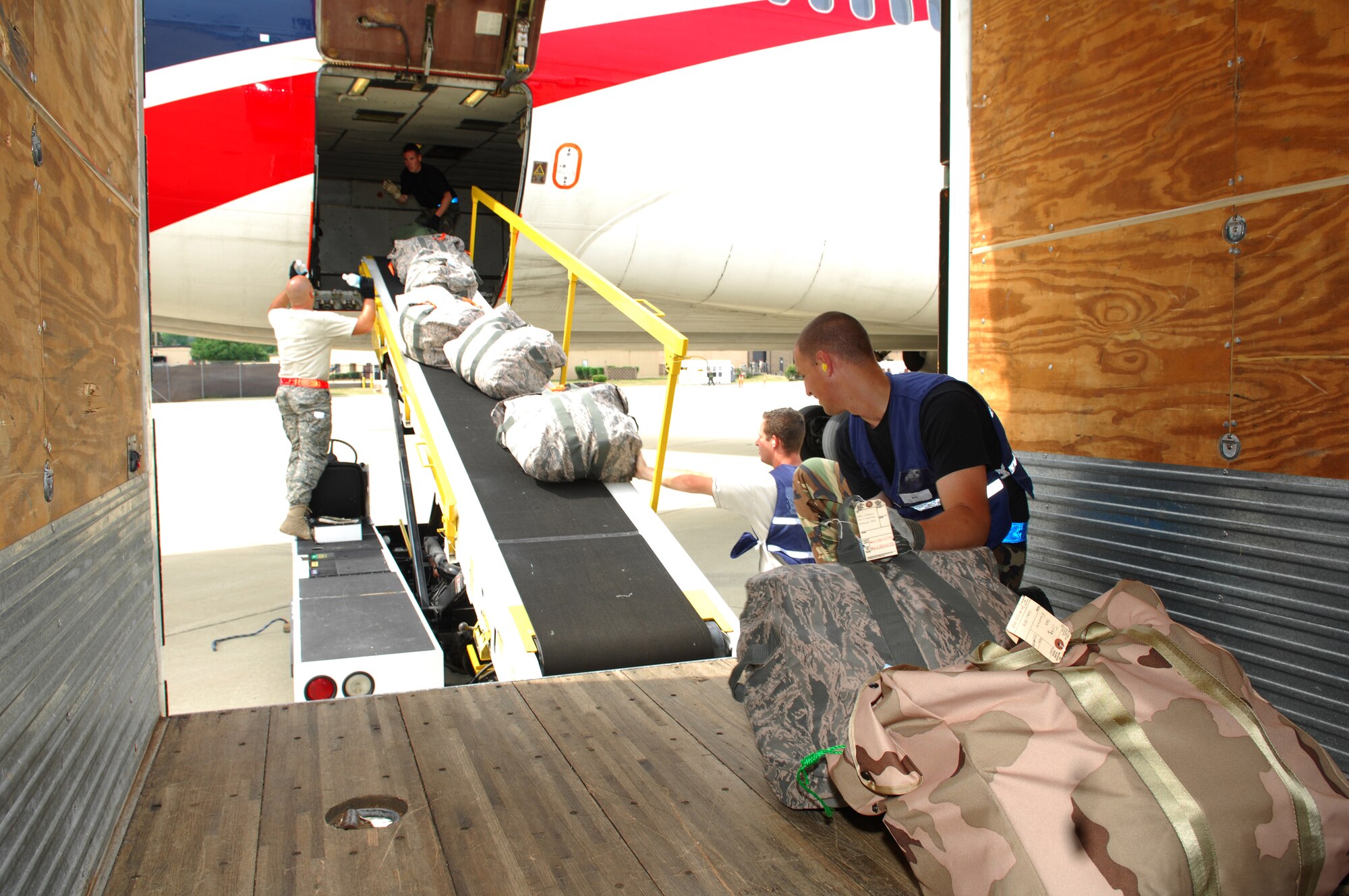SHAW AIR FORCE BASE, S.C.--  Airmen from the 20th Logistics Readiness Squadron load an airliner with baggage deploying with the 77th Fighter Squadron, May 22.  More than 200 Airmen from the 20th Fighter Wing are deploying to Southwest Asia to support the Global War on Terror. (U.S. Air Force photo/Senior Airman William Coleman)