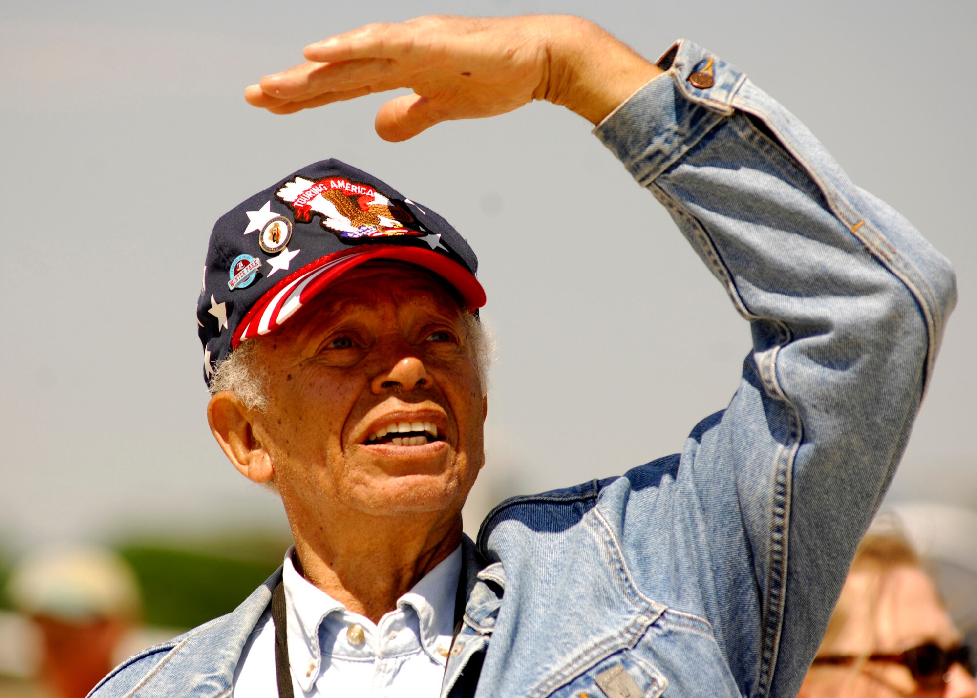 Mr. Herbert Gaskins watches the sky for the aerial aerobatic team performing at the 2008 Joint Service Open House hosted by Andrews Air Force Base, Md., May 17th.   This year?s event will have demonstrations by the Navy Blue Angels and the Army's Golden Knights.  Once again the JSOH will host a wide variety of both military and civilian air and ground demonstrations. To include the Air Force's newest and the world's most advanced fighter jet, the F-22A Raptor. (U.S. Air Force photo by Tech Sgt. Suzanne M. Day)(Released)
