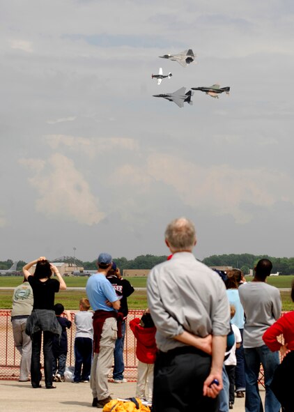 The crowd watches a formation fly by at the 2008 Joint Service Open House hosted by Andrews Air Force Base, Md. The 2009 JSOH takes place May 15-17 and will feature demonstrations by the Air Force Thunderbirds and the Army's Golden Knights. Once again the JSOH will host a wide variety of both military and civilian air and ground demonstrations. 
