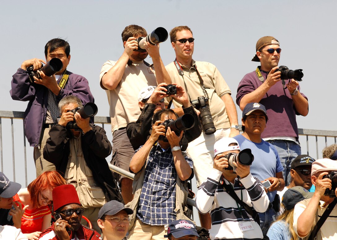 The crowd watches the sky for the F-22 Raptor at the 2008 Joint Service Open House hosted by Andrews Air Force Base, Md., May 17th.   This year?s event will have demonstrations by the Navy Blue Angels and the Army's Golden Knights.  Once again the JSOH will host a wide variety of both military and civilian air and ground demonstrations. To include the Air Force's newest and the world's most advanced fighter jet, the F-22A Raptor. (U.S. Air Force photo by Tech Sgt. Suzanne M. Day)(Released)
