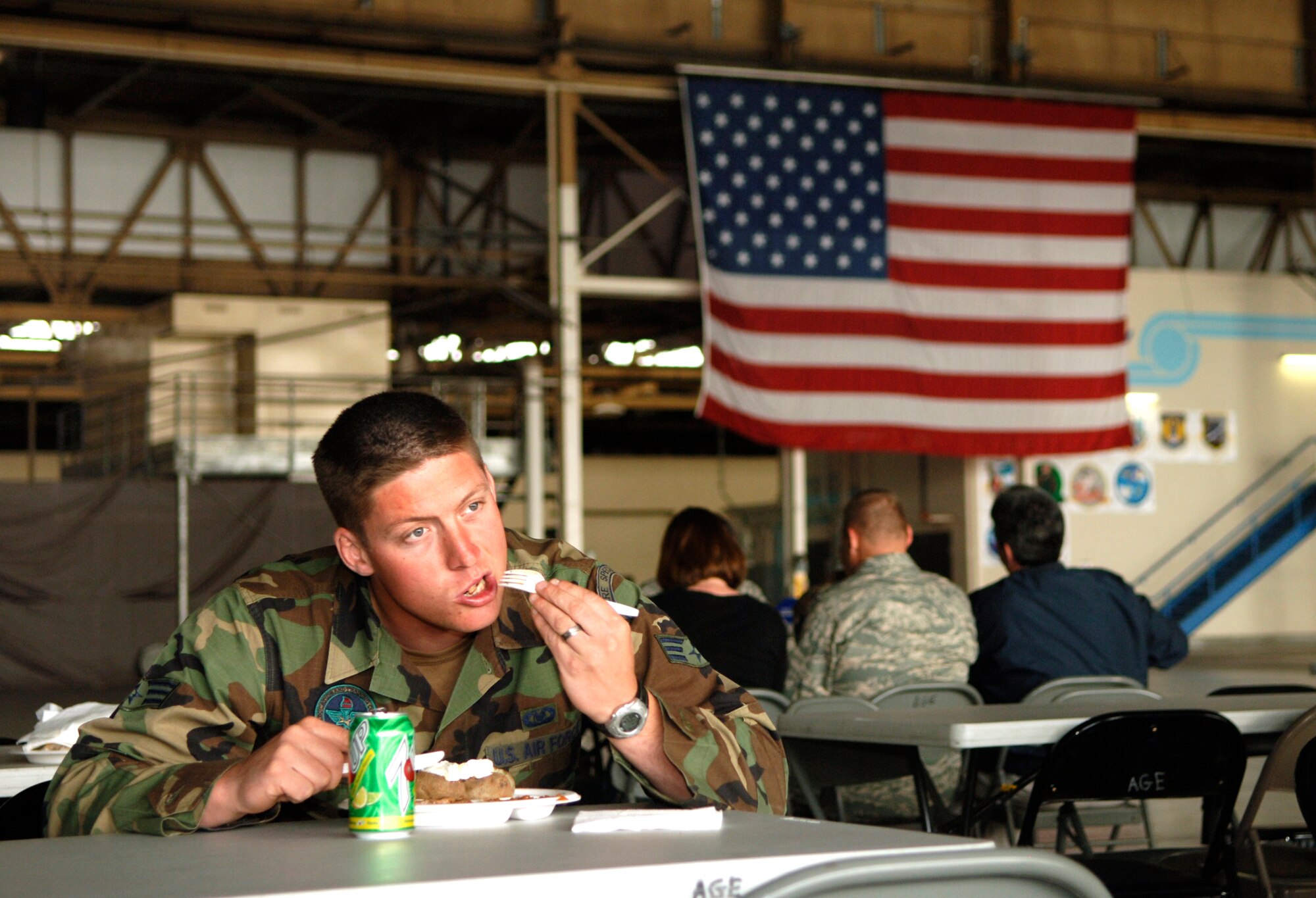 92nd Air Refueling Wing Command Chief Master Sgt. Paul Sikora serves steak to Senior Airman Christopher DeLange, 66th Training Squadron survival, evasion, resistance and escape instructor, during the Chief’s Steakout here May 21. Proceeds from the event are used to support 92nd Air Refueling Wing programs, such as annual awards, the Chief’s Recognition ceremony, numerous Airman Leadership School functions, junior enlisted personnel school scholarships and other causes. (U.S. Air Force photo / Airman 1st Class Joshua Chapman) 