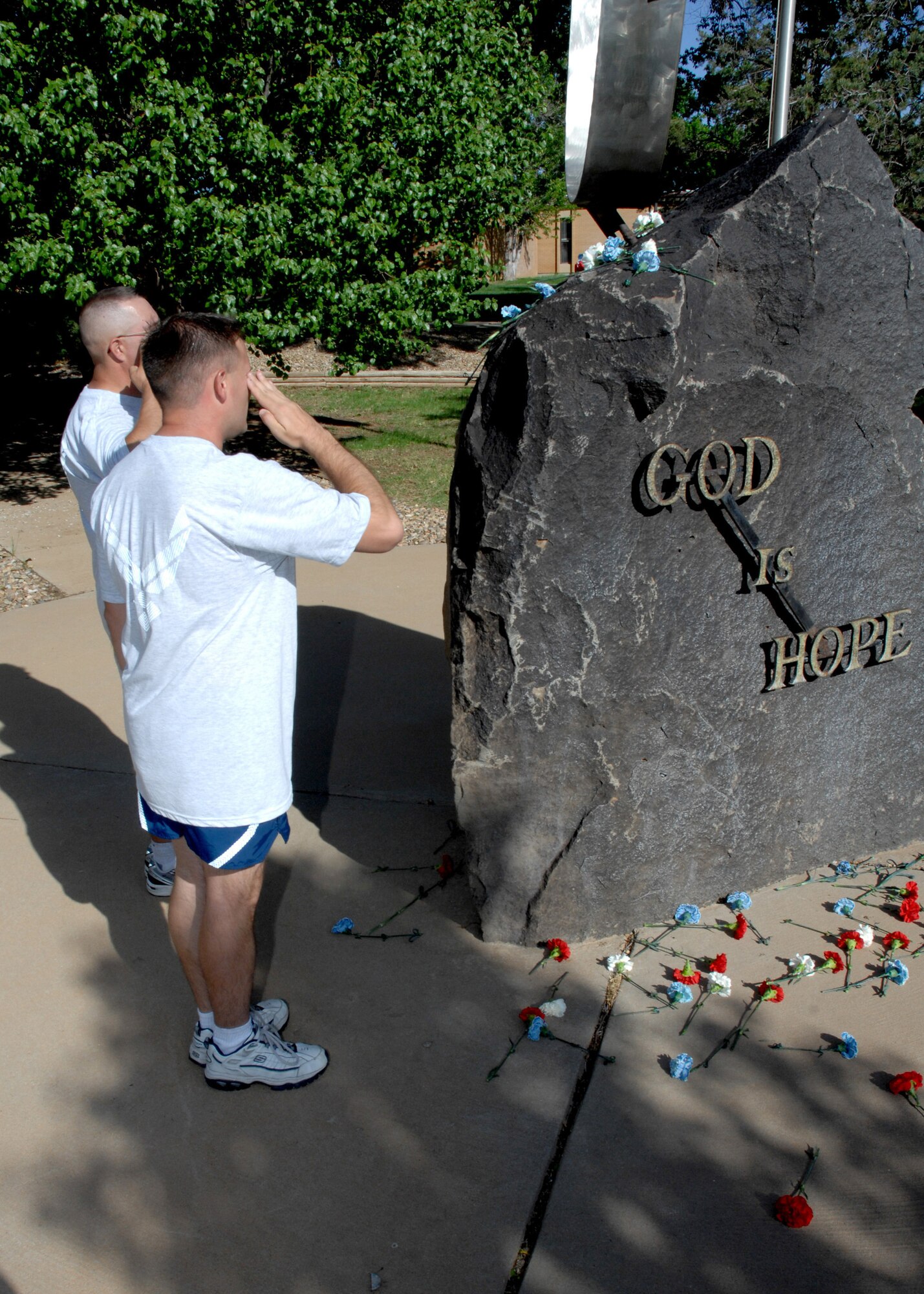 CANNON AIR FORCE BASE, N.M. -- Airmen stop to honor the fallen during the Gate- To-Gate Run on May 22. Military members and dependants participated in the annual 5.5-mile run. (U.S. Air Force photo/Airman 1st Class Evelyn Chavez)
