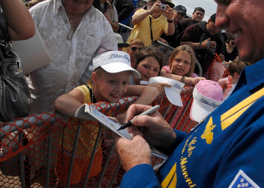 U.S. Navy Commander Kevin Mannix, Flight Leader and commanding officer for the U.S. Navy?s Flight Demonstration Squadron, the ?Blue Angels?, signs autographs at Andrews Air Force Base during its annual Joint Service Open House May 17.  The 2008 JSOH commemorated the 60th Anniversary of the Berlin Airlift and showcased the Navy Blue Angels, the Army's Golden Knights and a wide variety of both military and civilian air and ground demonstrations. (U.S. Air Force photo/Senior Airman Steven R. Doty)
