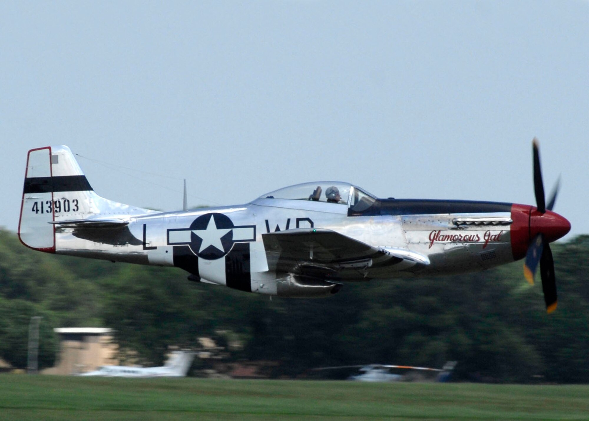 A P-51 Mustang makes a high speed pass at Andrews Air Force Base during its annual Joint Service Open House May 17.  The 2008 JSOH commemorated the 60th Anniversary of the Berlin Airlift and showcased the Navy Blue Angels, the Army's Golden Knights and a wide variety of both military and civilian air and ground demonstrations. (U.S. Air Force photo/Senior Airman Steven R. Doty)