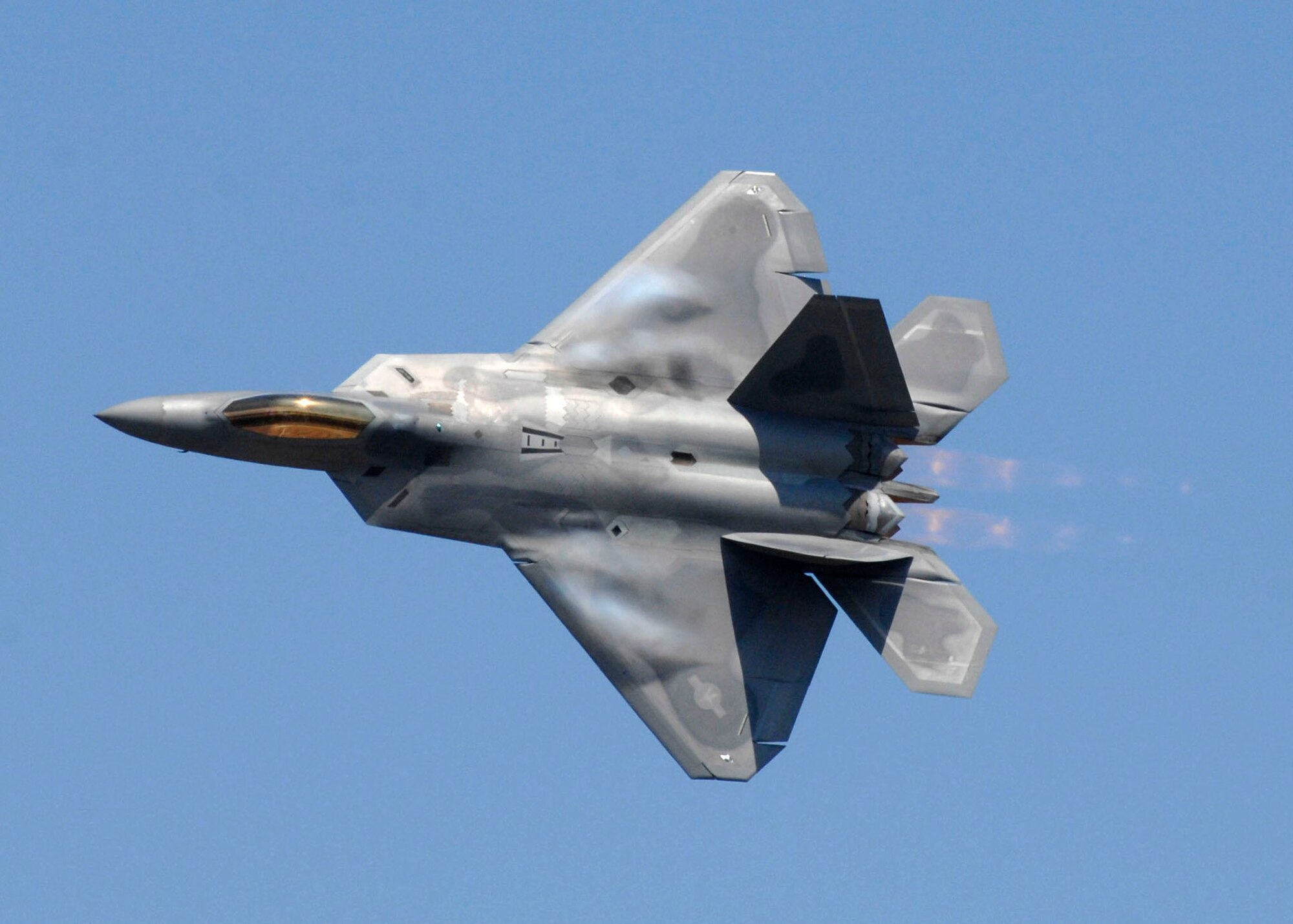 The F-22 Raptor performs maneuvers as it demonstrates its air superiority capabilities before 150,000 spectators during Andrews Air Force Bases? annual Joint Service Open House May 17.  The 2008 JSOH commemorated the 60th Anniversary of the Berlin Airlift and showcased the Navy Blue Angels, the Army's Golden Knights and a wide variety of both military and civilian air and ground demonstrations. (U.S. Air Force photo/Senior Airman Steven R. Doty)