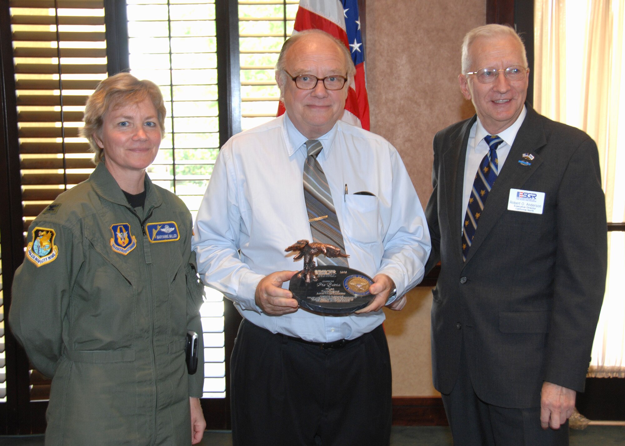 TRAVIS AIR FORCE BASE, Calif. -- Mr. Bert Gaulke, chairman of the Travis Regional Armed Forces Committee (center), accepts the highest state-level Department of Defense award for civilian employers here May 19 from Mr. Robert O. Anderson, Executive Director of California-North committee for Employer Support of the Guard and Reserve (right), and is thanked by Col.  Maryanne Miller, commander of the 349th Air Mobility Wing (left).  The Pro Patria Award honors employers which make extraordinary efforts to adopt policies and take actions supporting employees serving in the Guard and reserve.  Only one Pro Patria Award is presented by each state ESGR committee annually. The Travis Regional Armed Forces Committee is a local community organization dedicated to supporting the Airmen and missions of Travis Air Force Base. Its membership is comprised of more than 150 local business and civic leaders. The ESGR operates through a network of more than 4,200 volunteers in 54 committees located in each state, the District of Columbia, Guam, Puerto Rico, the Virgin Islands and Europe. The California-North ESGR Committee promotes understanding of the National Guard and Reserve with both public and private sector employers. (U.S. Air Force / Maj. Robert Couse-Baker)
