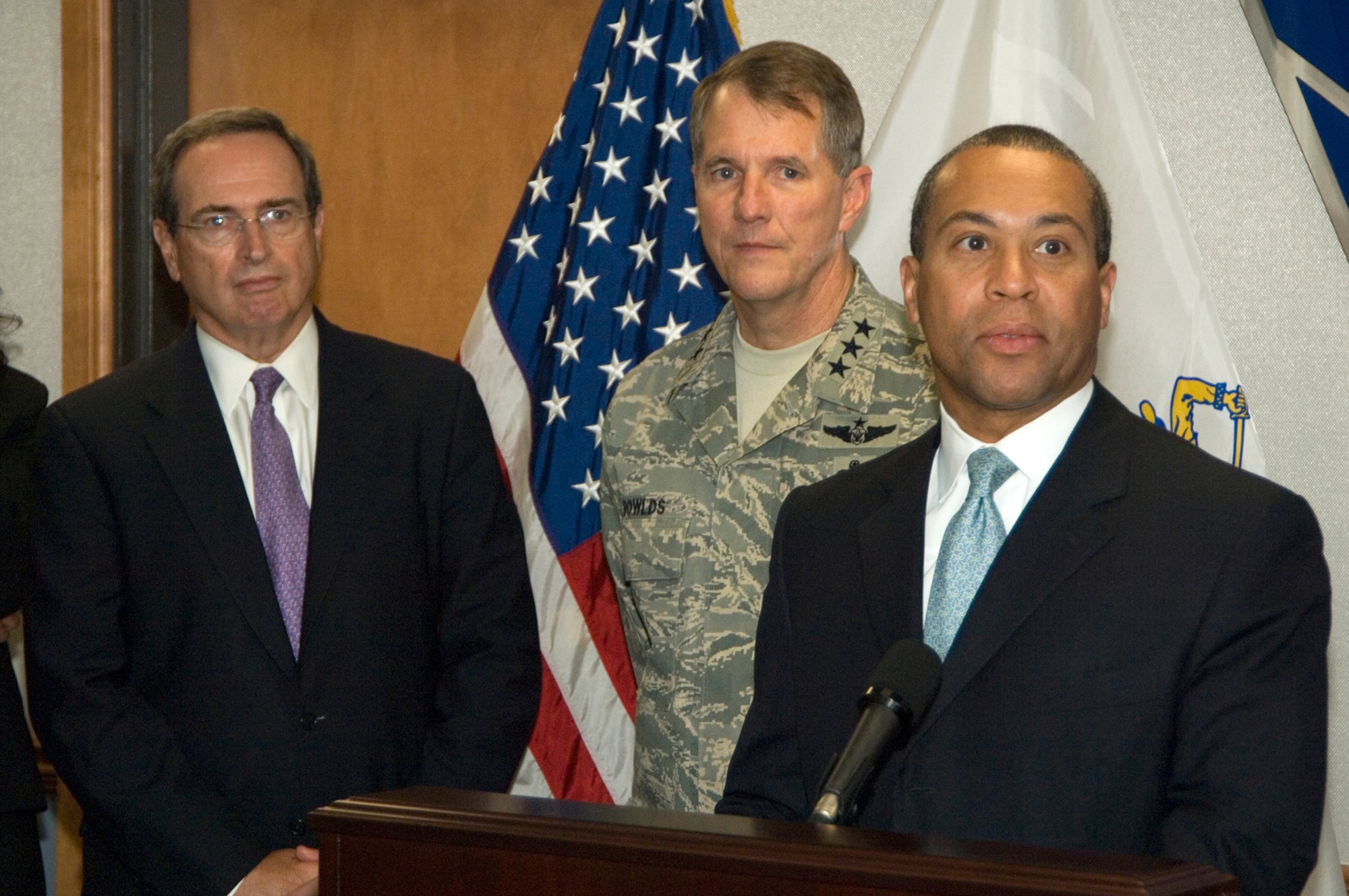 HANSCOM AFB, Mass. - Mass. Governor Deval Patrick addresses members of the press and staff members at Hanscom AFB during a visit to the base today, as Mass. Secretary for Public Safety Kevin Burke and Air Force Electronic Systems Center Commander Lt. Gen. Ted Bowlds look on. (U.S. Air Force Photo by Mark Wyatt)

