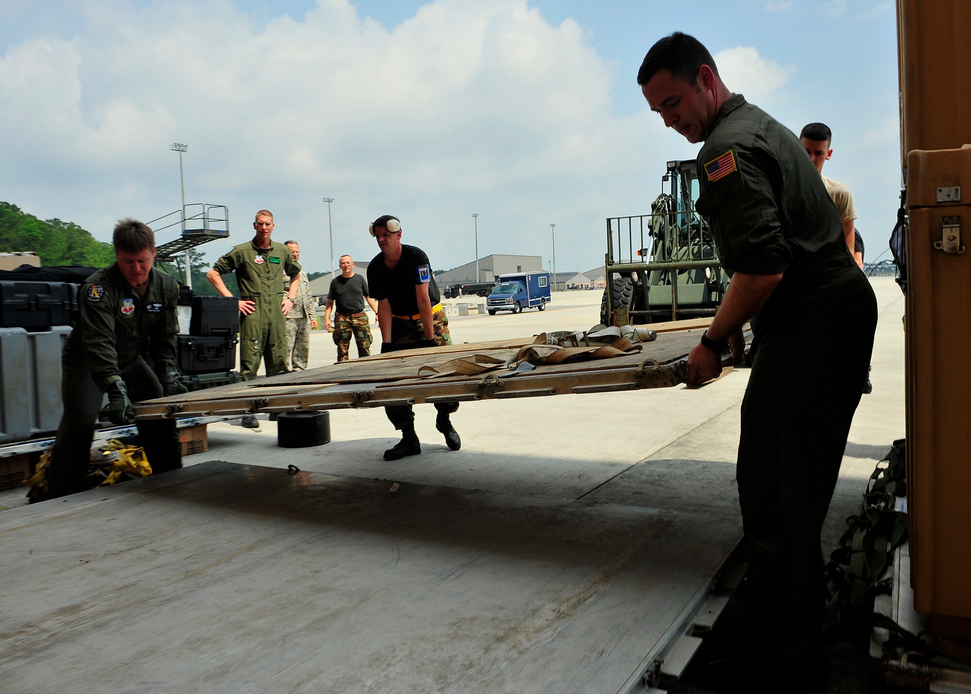 MOODY AIR FORCE BASE, Ga. -- Airmen of the 23rd Wing carry a pallet into a cargo loading area during a hurricane evacuation exercise here May 21. The pallets will be loaded with mission essential equipment to operate in a storm-ravaged deployed location. (U.S. Air Force photo by Senior Airman Elizabeth Rissmiller)
