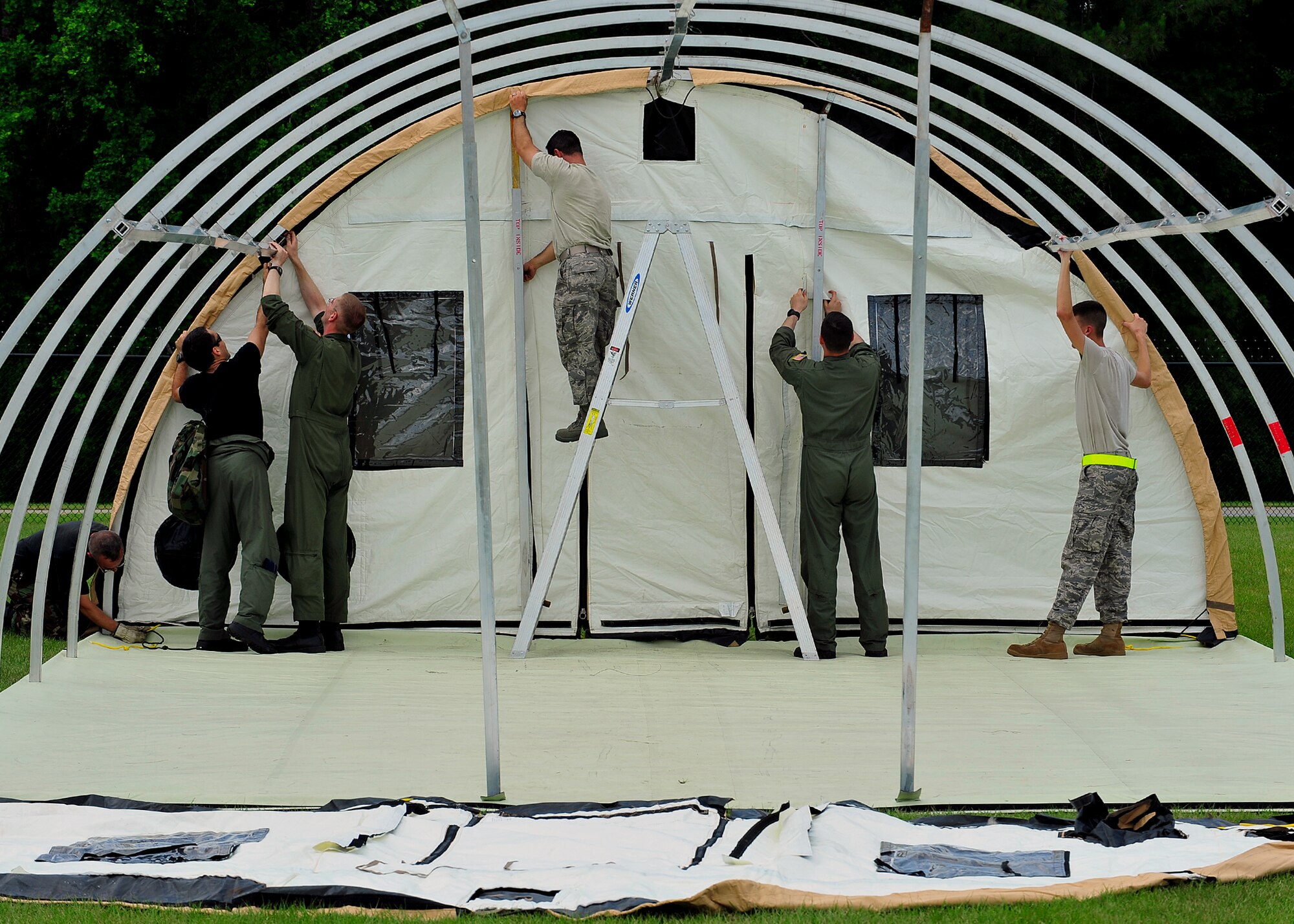 MOODY AIR FORCE BASE, Ga. -- Airmen of the 23rd Wing work together to build a tent during a hurricane evacuation exercise here May 21. The exercise helps Airmen plan accordingly if a real-world catastrophe occurred. (U.S. Air Force photo by Senior Airman Elizabeth Rissmiller)