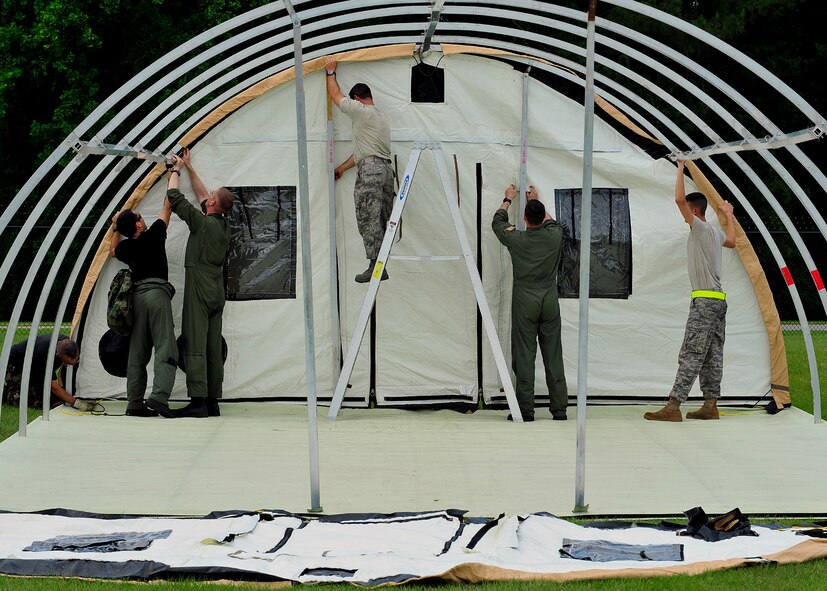 MOODY AIR FORCE BASE, Ga. -- Airmen from the 23rd Wing work together to build a tent during the Global Response Force exercise here May 21. The exercise helped the wing plan civilian rescue operations in response to possible real-world catastrophes. (U.S. Air Force photo by Senior Airman Elizabeth Rissmiller) 
