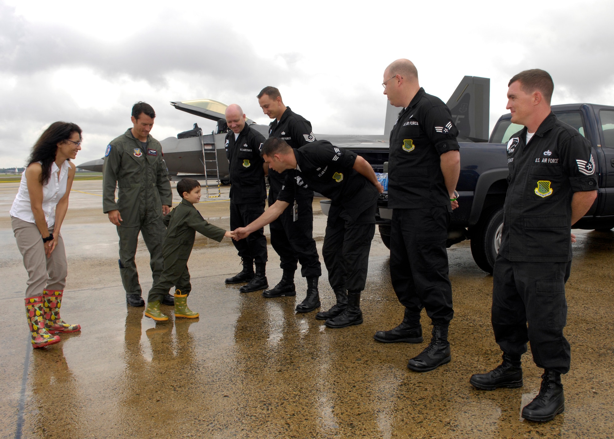 Brandon Leach shakes hands with the crew members of the F-22 Raptor team during his tour of the Joint Service Open Hosue at Andrews Air Force Base Md., on May 16, 2008. Brandon got a tour as a part of the "Pilot for a Day" program that is conducted a few times every year. (U.S. Air Force photo by Senior Airman Renae Kleckner)(released)