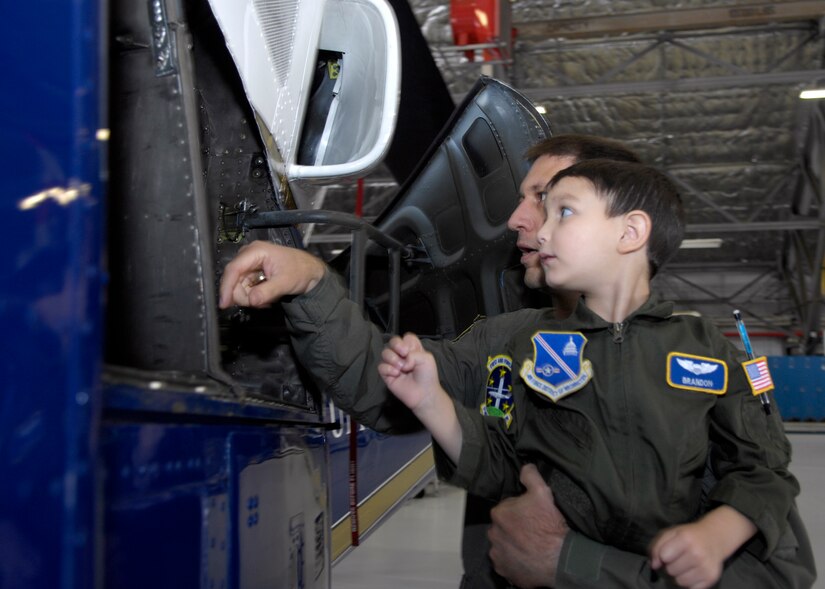 Lt Col Donald Snyder, 1st Helicopter Squadron Commander, looks at the engines with Brandon Leach, the "Pilot for a Day" during his tour of Hangar 1 at Andrews Air Force Base, Md., on May 16, 2008. Michael got a tour from the 1st Helicopter Squadron as well as various parts of the Open House such as the F-22 Raptor and the Blue Angels. (U.S. Air Force photo by Senior Airman Renae Kleckner)(released)
