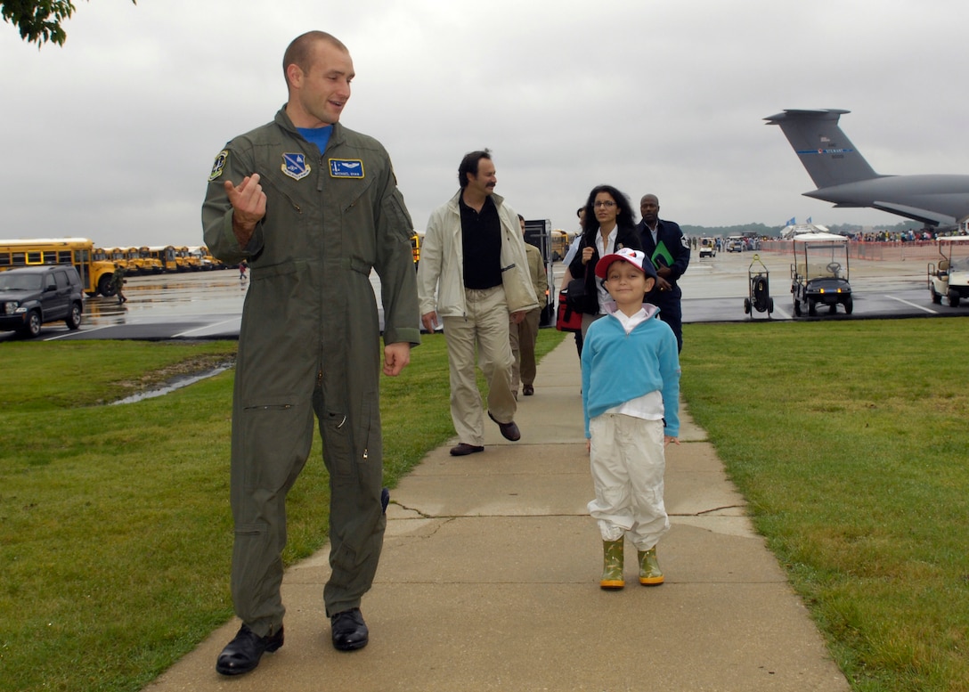 1st Lt Michael Ryan, 1st Helicopter Squadron, escorts Brandon Leach, the "Pilot for the Day" into Hangar 1 at the Andrews Air Force Base Joint Service Open House on May 16, 2008. The Pilot for a Day program is a chance for terminally ill children to get special treatment for a day. (U.S. Air Force photo by Senior Airman Renae Kleckner)(released)