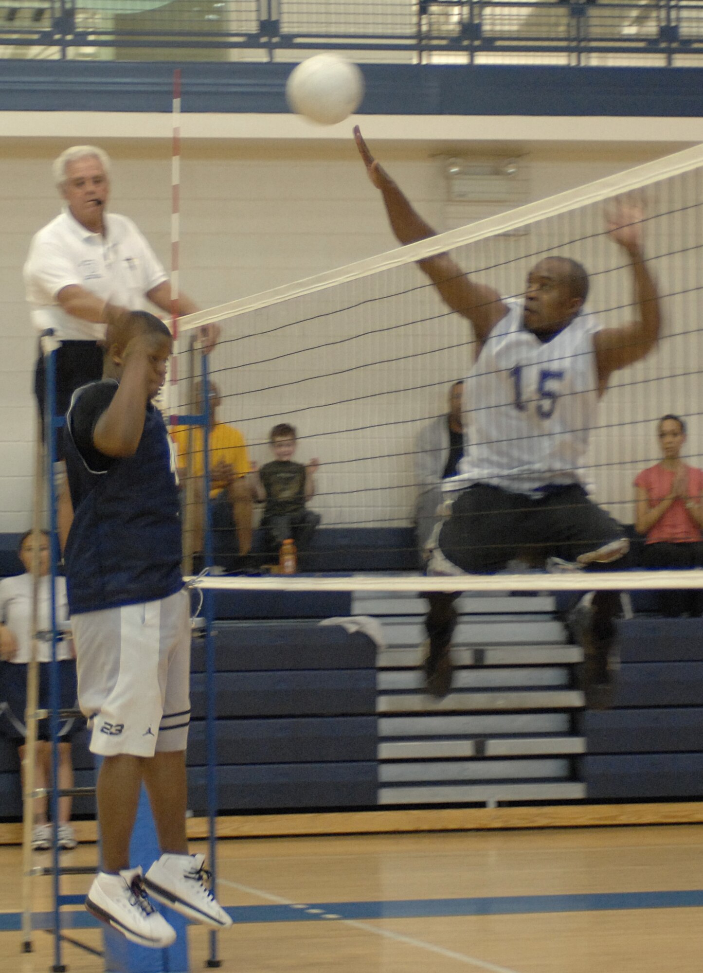 LANGLEY AIR FORCE BASE, Va. -- Airman 1st Class Brye McMillon (left), 1st Contracting Squadron , prepares to block while Staff Sgt. Kevin Moore (right), 735th Supply Chain Management Group, begins to spike the ball during the intramural championship game May 21. The 735th SCMG team won the game 25 to 18 against the Air Combat Command Operations Directorate team to become Langley’s intramural volleyball champions. (U.S. Air Force photo/Tech. Sgt. April Wickes)