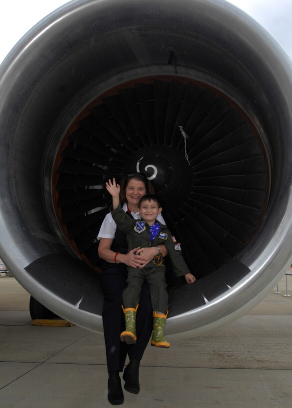 Liz Reardon, Delta Flight Attendant, holds Brandon Leach, Pilot for a day, in the engine on the Boeing 757 on 16 May 2008 at the Joint Service Open House Air Show held on Andrews AFB, MD. (USAF Photo by Senior Airman Melissa Stonecipher)