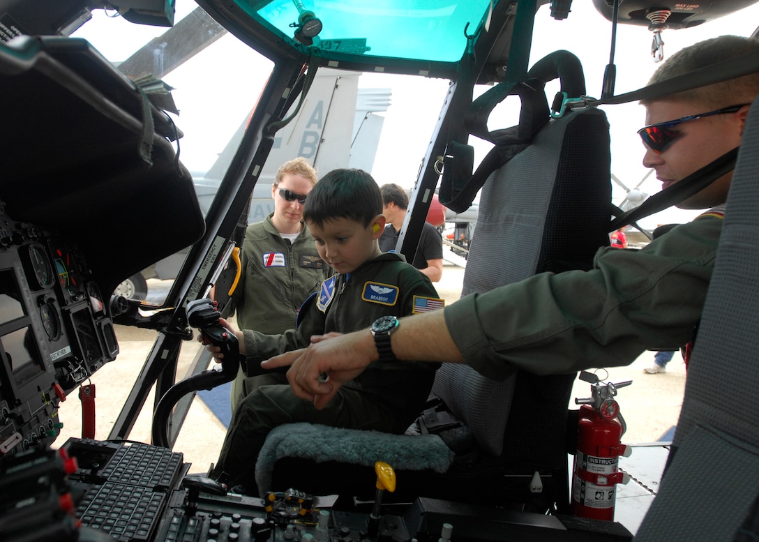 Aviation Survival Technician 2 (E-5) Tye Conklin, US Coast Guard, talks to  Brandon Leach, Pilot for a day, about the features of the Coast Guard Helicopter on 16 May 2008 at the Joint Service Open House Air Show held on Andrews AFB, MD. (USAF Photo by Senior Airman Melissa Stonecipher) 