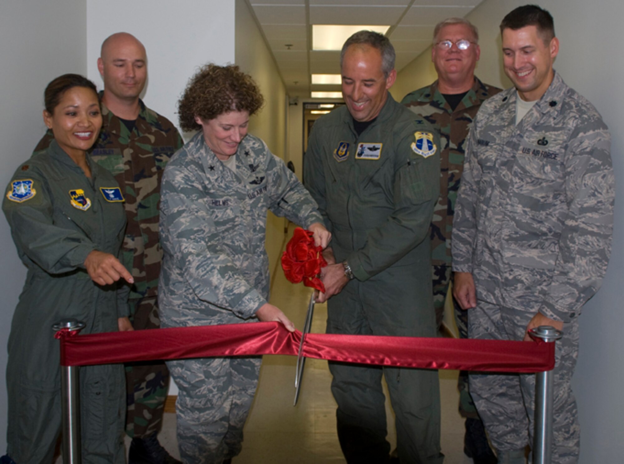PATRICK AIR FORCE BASE, Fla.  -- Brig. Gen. Susan Helms, 45th Space Wing commander, and Col. Steven Kirkpatrick, 920th Rescue Wing commander, cut the ribbon to mark the opening of the joint active duty-reserve command post at Patrick AFB.  Helping during the ribbon cutting were (from left) Maj. Janice Hance, 45th SW Command Post; Tech. Sgt. Anthony Beasley, 45th Civil Engineer Squadron; Lt. Col. Rex Meyers, 920th RQW Command Post; and Lt. Col. Jerald Narum, 45th Space Communications Squadron. (U.S. Air Force photo)