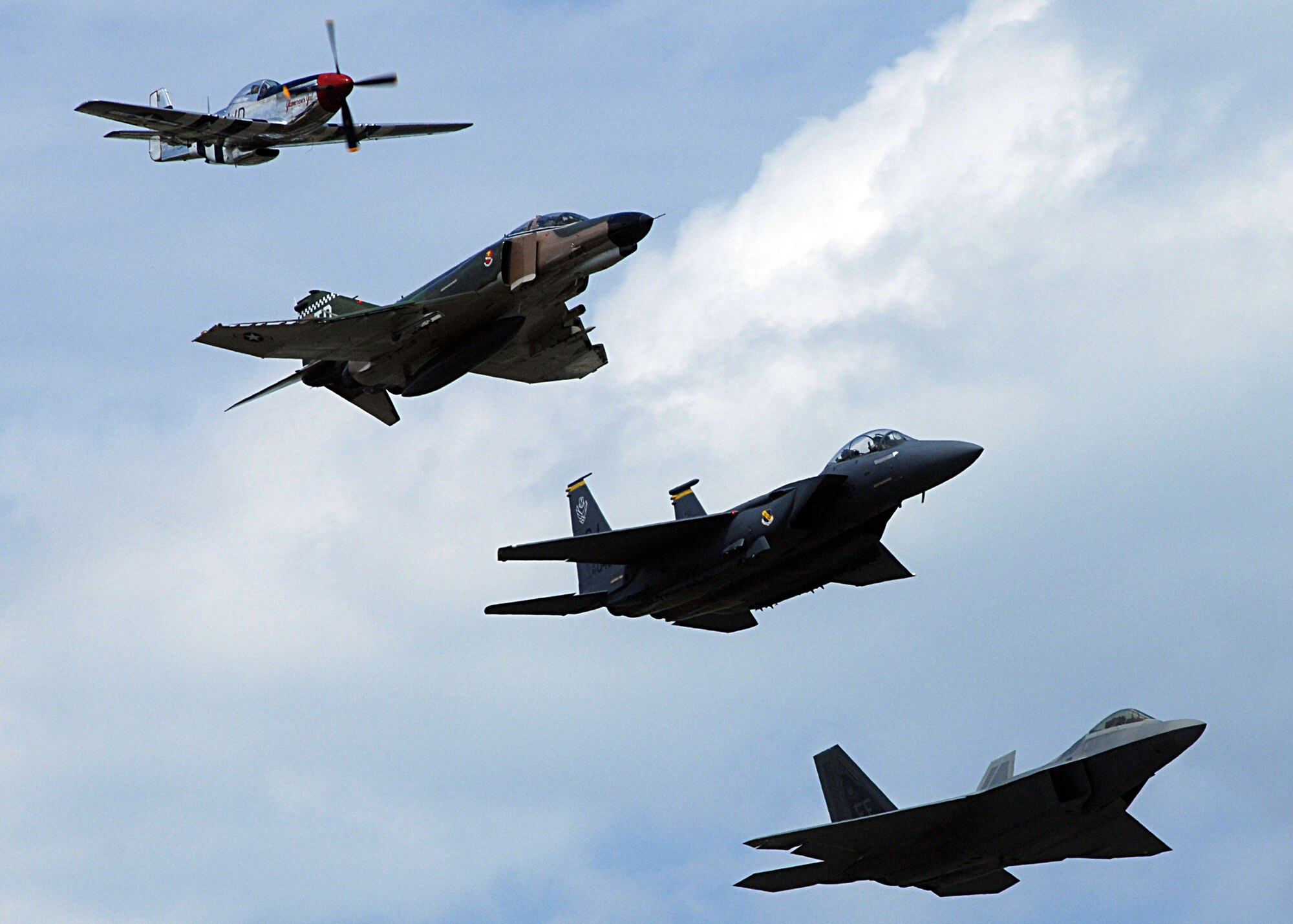 The Air Combat Command Heritage Flight took to the skies over Andrews Air Force Base, Va.,  during the Joint Service Open House May 17.  The Heritage Flight consists of a P-51 Mustang (top), an F-4 Phantom, an F-15E Strike Eagle, an F-22A Raptor.   The F-4s used in the Heritage flights are owned and operated by the 82nd Aerial Targets Squadron from Tyndall Air Force Base, Fla.  Photo by Amn Melissa Rodrigues.