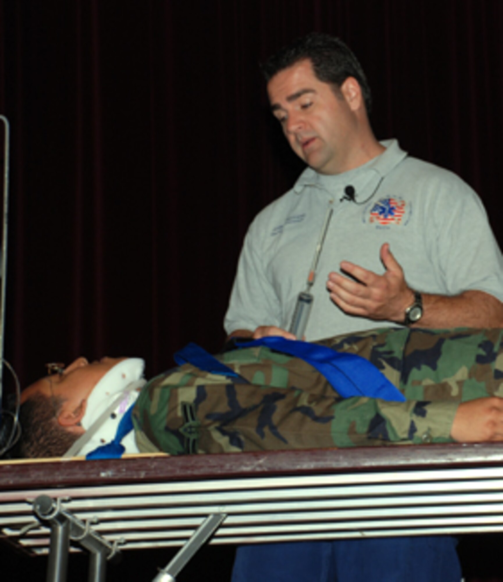 Joseph McCluan, a presenter at the Street Smart seminars May 15-17, uses Airman 1st Class David Salazar, a Help Desk technician with the 82nd Communications Squadron, to demonstrates the methods used to save lives of trauma victims that drive without a seatbelt or while intoxicated. (U.S. Air Force photo/Airman 1st Class Candy Miller) 
