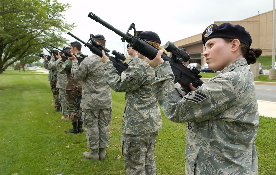 Staff Sgt. Kimberly Rodgers, 436th SFS, and six other members of the firing team perform the 21 gun salute as each Airman fires their rifle three times. The 436th Security Forces Airmen performed retreat to honor National Police Week, a time to honor those in the law enforcement profession who have paid the ultimate sacrifice. (U.S. Air Force photo/Jason Minto)