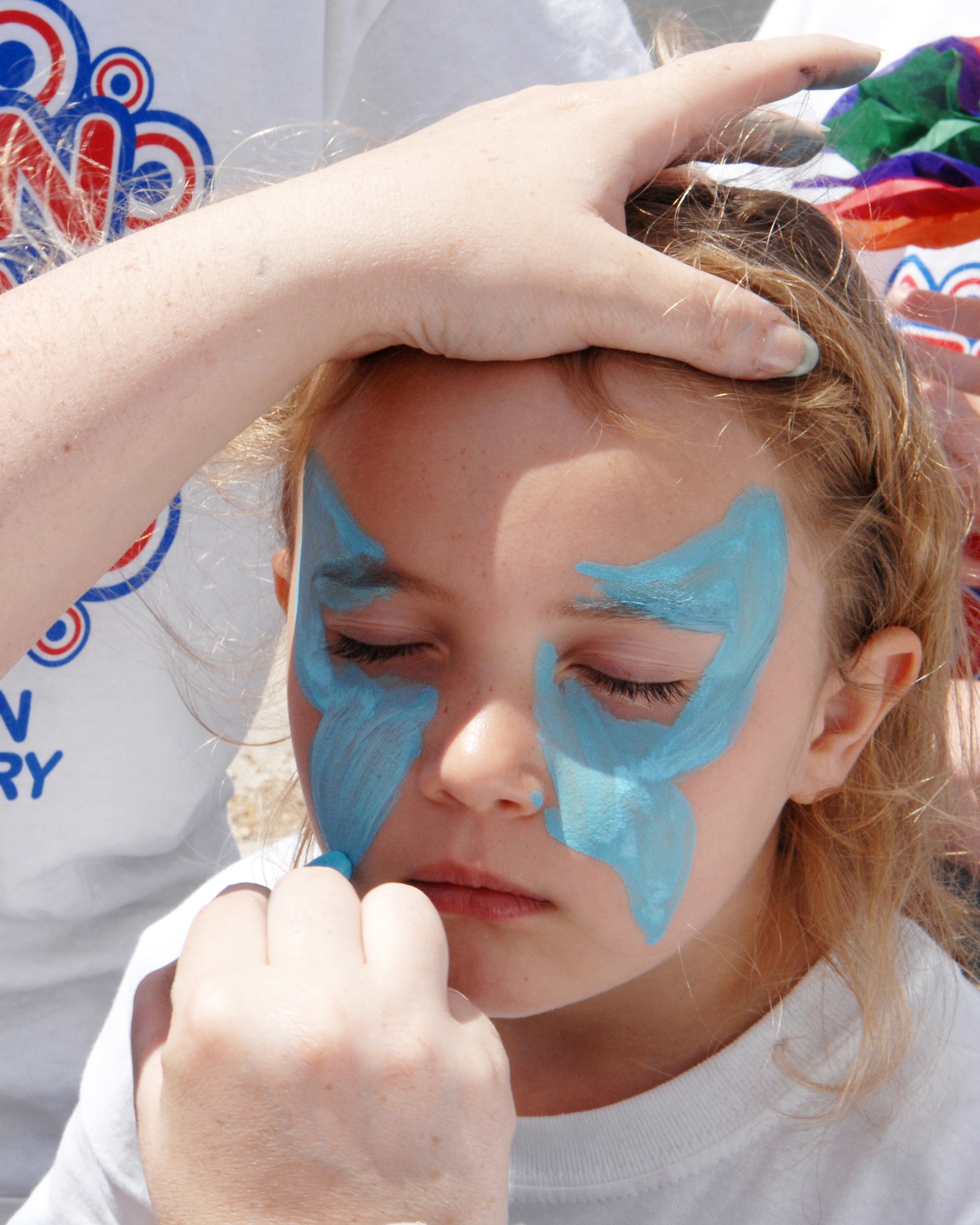 WHITEMAN AIR FORCE BASE, Mo. - Kayla Dugan gets a butterfly painted on her face during Whiteman Elementary's Kids' Day 2008 Wednesday. Kids day isa day full of fun events for children to kick off the beginning of summer vacation. (U.S. Air Force photo/Senior Airman Jessica Snow)