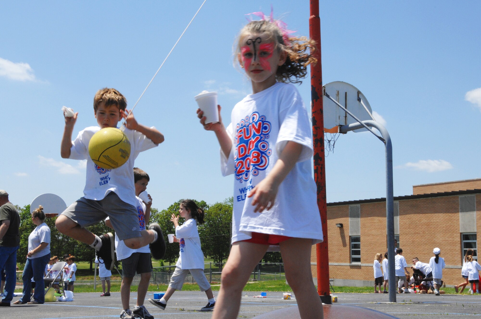 WHITEMAN AIR FORCE BASE, Mo. - Damon Teel (left) gets ready to return a teatherball to his opponent as another child walks by during Whiteman Elementary's Kids' Day 2008. Kids' Day is the school's way of kickign off the beginnign of sumemr vacation for children and teachers. (U.S. Air Force photo/Senior Airman Jessica Snow)