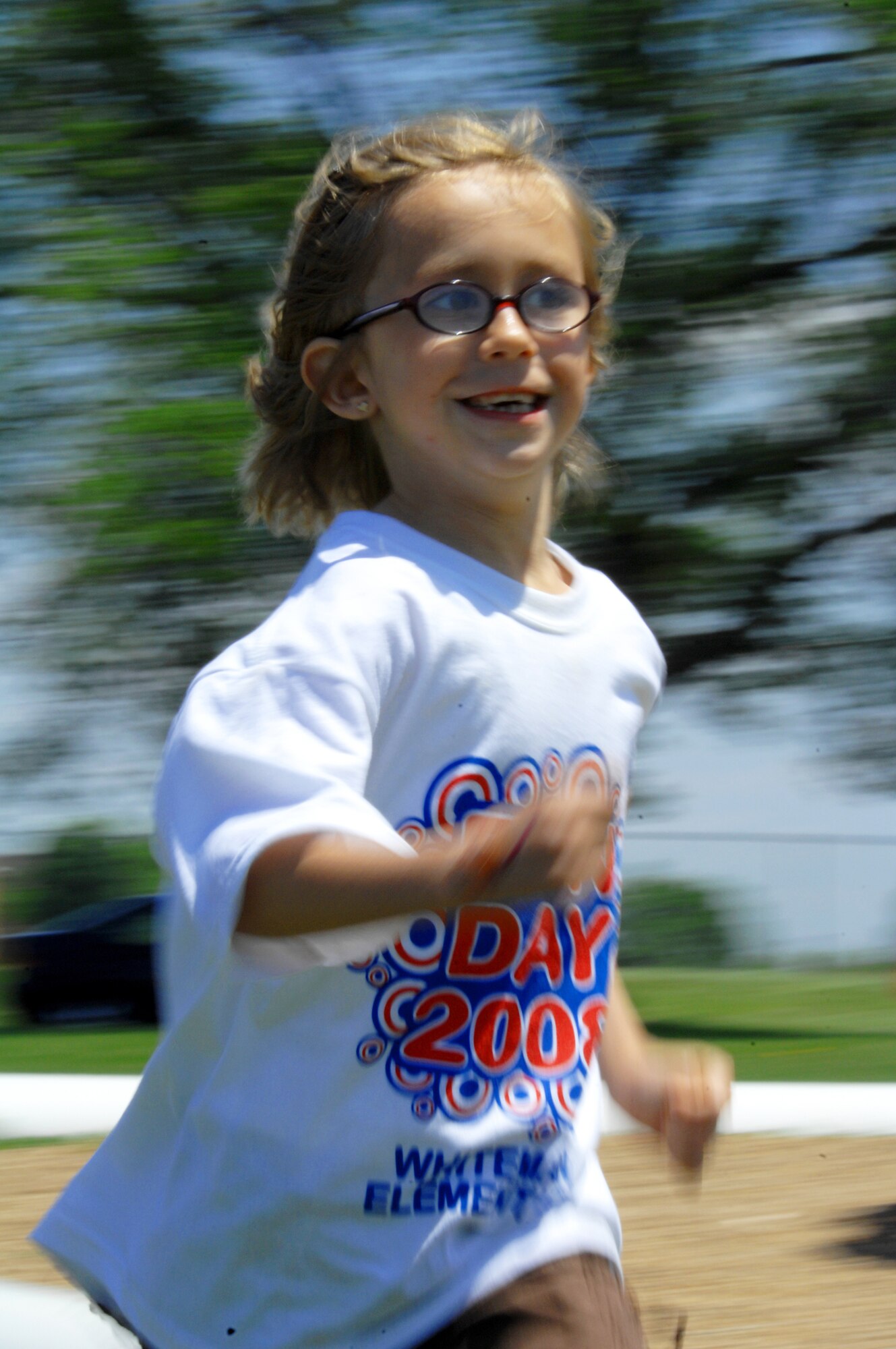 WHITEMAN AIR FORCE BASE, Mo. - Abigail McCurter runs and enjoys the events during Whiteman Elementary's Kids' Day 2008 Wednesday. Kids' Day is a day full fo fun events for children to kick off the start of summer vacation. (Senior Airman Jessica Snow)
