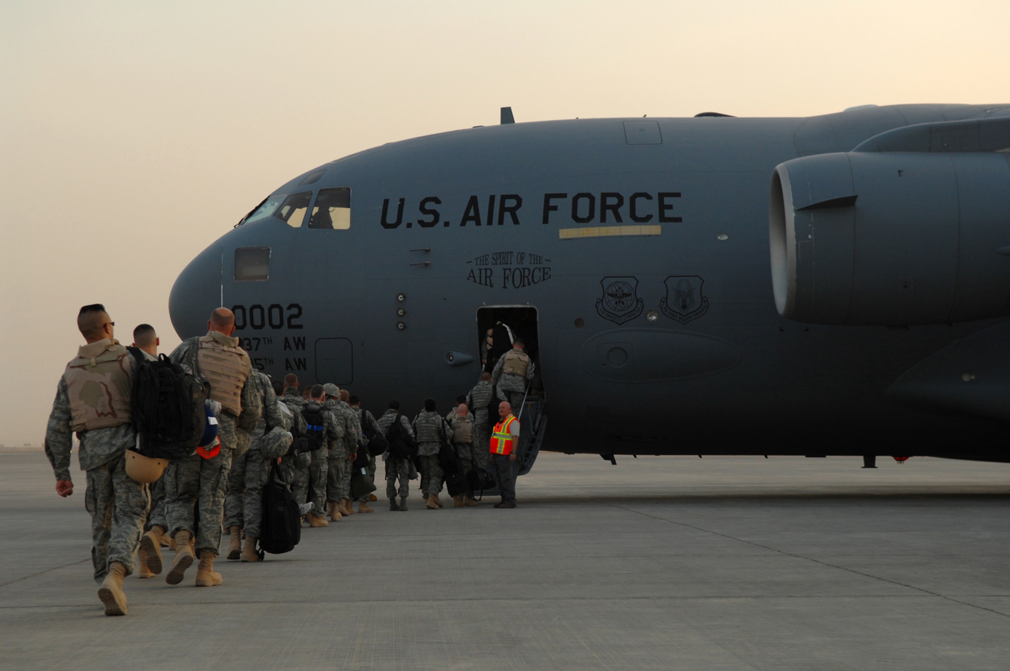 BALAD AIR BASE, Iraq -- Airmen assigned to the 332nd Air Expeditionary Wing board a C-17 Globemaster III here, May 21. The Airmen, many of whom deployed under the Air Expeditionary Force 1 and 2 rotations, are re-deploying to their home stations following successful four and six-month tours in Iraq. During AEF 1 and 2, Balad Airmen controlled 327,000 square miles of airspace, built a $9.6 million combat search and rescue helicopter ramp and in- and out-processed more than 8,000 Airmen and civilians. (U.S. Air Force photo/ Senior Airman Julianne Showalter)