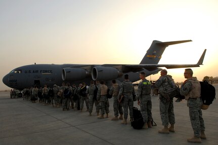 BALAD AIR BASE, Iraq -- Airmen assigned to the 332nd Air Expeditionary Wing board a C-17 Globemaster III here, May 21. The Airmen, many of whom deployed under the Air Expeditionary Force 1 and 2 rotations, are re-deploying to their home stations following successful four and six-month tours in Iraq. The 332 AEW is the most forward deployed Air Force wing in Iraq. On a monthly basis, Balad logistics readiness experts process more than 950 cargo aircraft, 12,000 tons of cargo and 19,000 passengers making it the busiest aerial port operation in the Department of Defense. (U.S. Air Force photo/ Senior Airman Julianne Showalter)