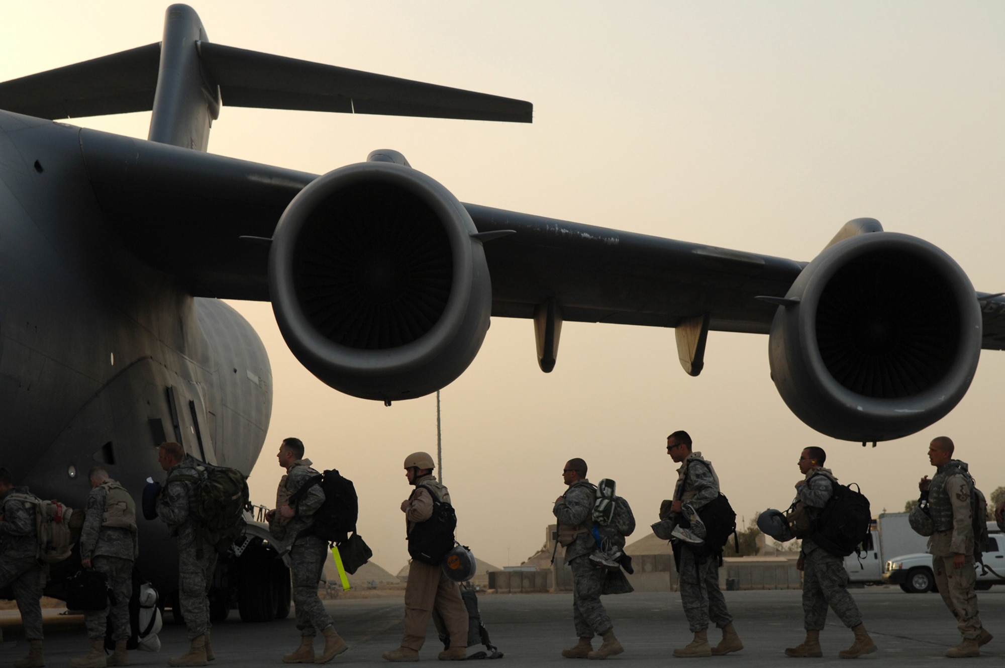 BALAD AIR BASE, Iraq -- Airmen assigned to the 332nd Air Expeditionary Wing board a C-17 Globemaster III here, May 21. The Airmen, many of whom deployed under the Air Expeditionary Force 1 and 2 rotations, are re-deploying to their home stations following successful four and six-month tours in Iraq. During AEF 1 and 2, Balad Airmen flew more than 1,000 unmanned aerial vehicle Predator sorties, moved 4,300 tons of cargo and poured 5,800 cubic meters of concrete. (U.S. Air Force photo/ Senior Airman Julianne Showalter)