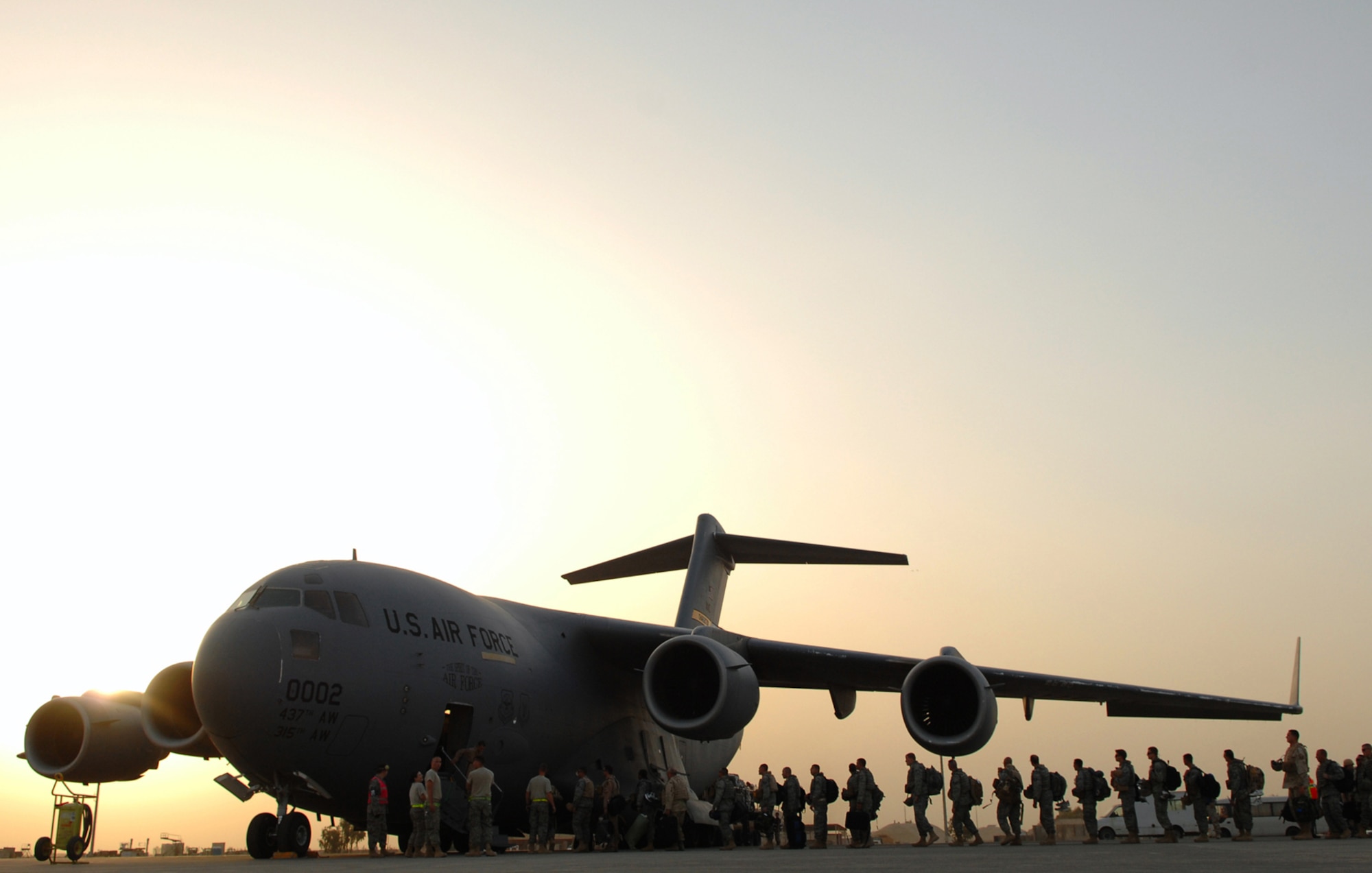 BALAD AIR BASE, Iraq -- Airmen assigned to the 332nd Air Expeditionary Wing board a C-17 Globemaster III here, May 21. The Airmen, many of whom deployed under the Air Expeditionary Force 1 and 2 rotations, are re-deploying to their home stations following successful four and six-month tours in Iraq. During AEF 1 and 2, Balad Airmen flew more than 4,000 F-16 sorties, assembled 17,400 units of ammunition and treated more than 13,500 patients at the clinic and Air Force Theater Hospital. (U.S. Air Force photo/ Senior Airman Julianne Showalter)