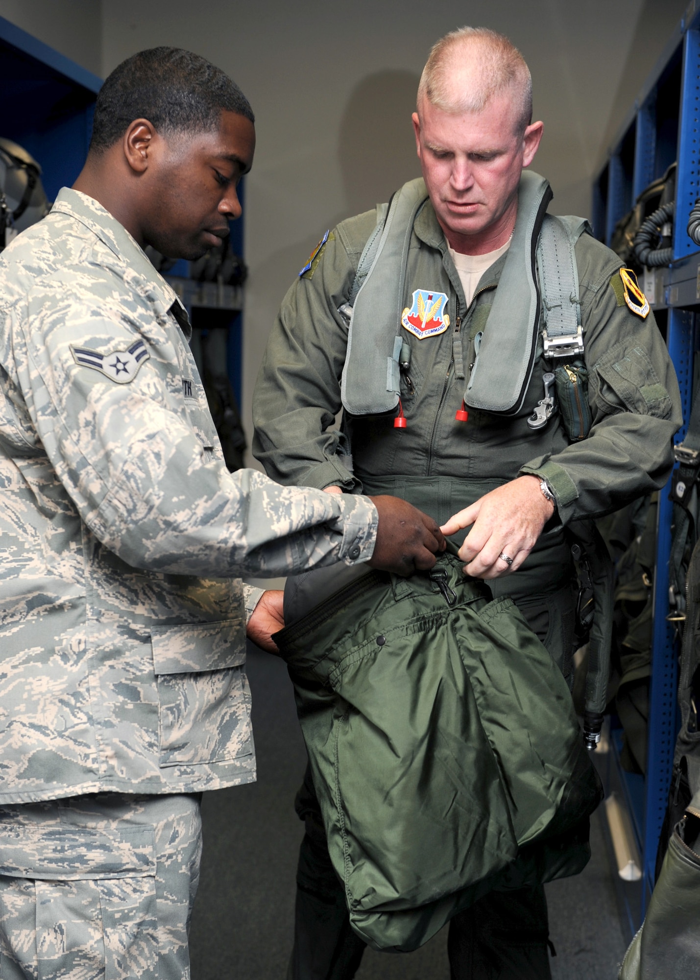 Benjamin Smith, 4th Operations Support Squadron, hands the helmet bag to Chief Master Sergeant Layton Clark, 4th Fighter Wing Command Chief, at Seymour Johnson AFB, North Carolina, May 12, 2008.Chief Clark received the incentive flight as part of his farewell before he departs Seymour Johnson AFB for his new assignment at Langley AFB, Virginia.  
(US Air Force photo by Airman First Class Salma Nebot)(Released)
