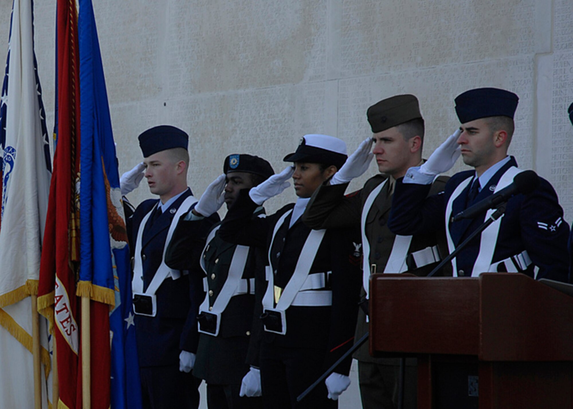 European Command Joint Analysis Center Color Guard salute the colors during a Veteran's Day Remembrance Ceremony at Madingley American Cemetery, Nov 12, 2007 (U.S. Air Force photo by Senior Airman Brian J. Ellis)