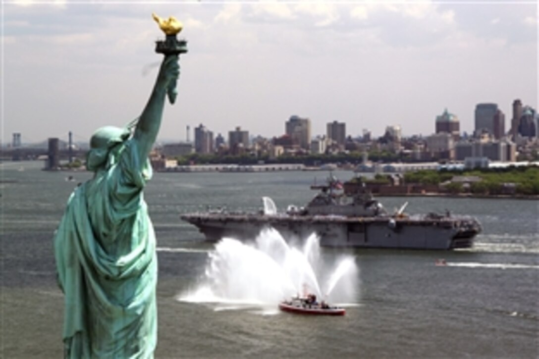 The amphibious assault ship USS Kearsarge passes by the Statue of Liberty as it steams up the Hudson River during the Parade of Ships for Fleet Week New York, May 21, 2008. More than 4,000 sailors, Marines, and Coast Guardsmen will participate in various community relations projects and make a port call to New York City. 