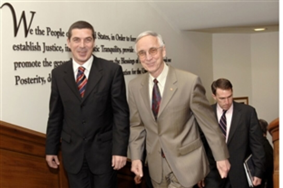 U.S. Deputy Secretary of Defense Gordon England (right) escorts visiting Albanian Minister of Defense Gazmend Oketa to his Pentagon office, May 22, 2008, where they held bilateral security talks on a variety of regional issues.  
