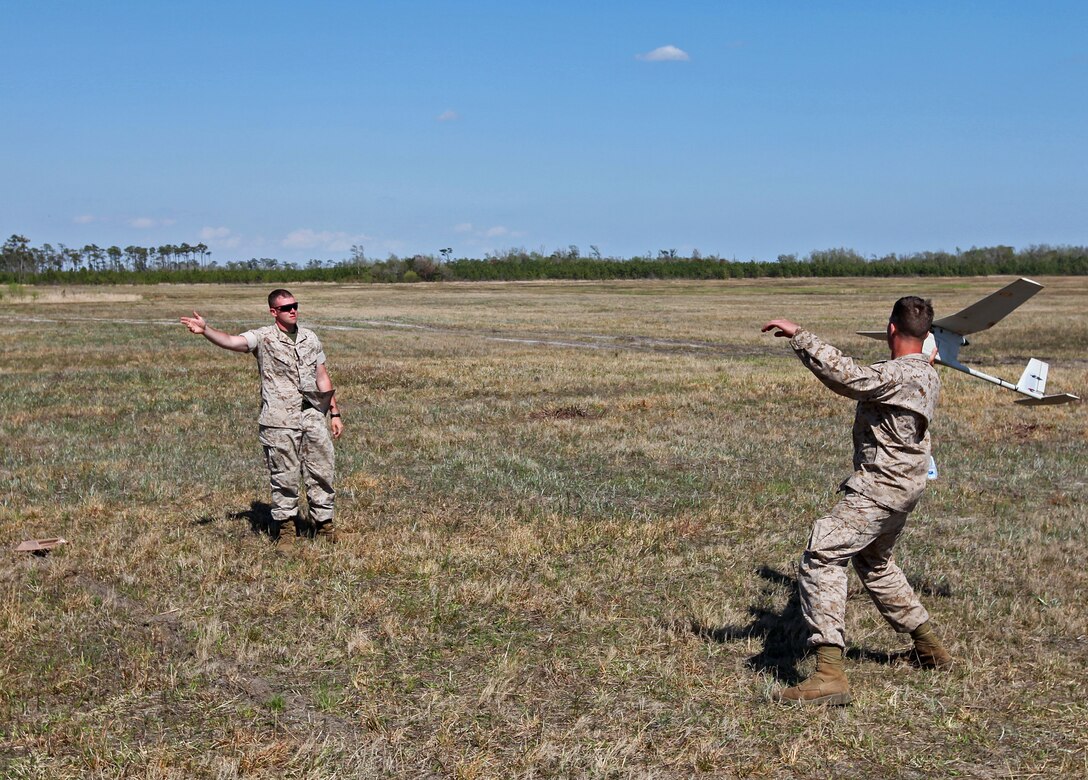 Cpl. Lukas Boyle and Lance Cpl. James Hunt, fire support Marines with 2nd Air-Naval Gunfire Liaison Company, II Marine Expeditionary Force, launch a Raven-B unmanned aerial vehicle aboard Marine Corps Base Camp Lejeune, N.C., April 9, 2010. During a five-day UAV certification course, Boyle, Hunt and other ANGLICO Marines learned how to launch, operate and recover the Raven-B.
