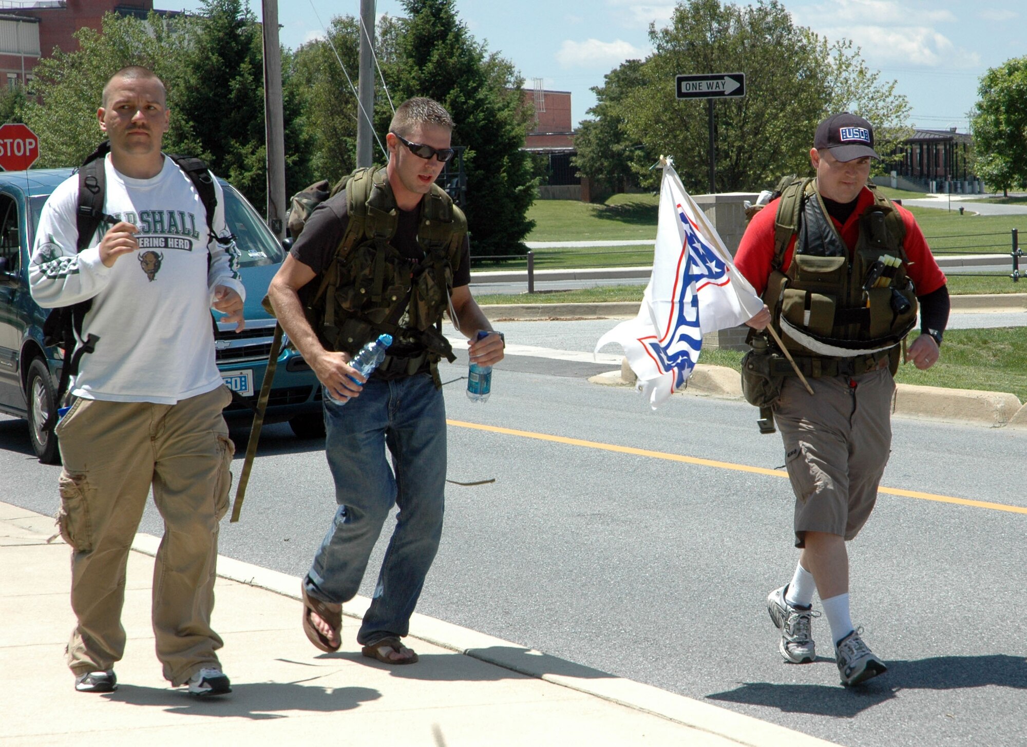 DOVER AIR FORCE BASE, Del. -- From right to left, Tech. Sgt. David Jackson, 29, from the Air Force Reserve's 512th Airlift Wing, and 436th AW members Airman 1st Class Joseph Pelkey, 20, and Staff Sgt. William East, 28, finished a 47-mile trek  from New Castle to Dover at 12:40 p.m. today. The Airmen finished the march to raise funds for USO Delaware in 19 hours and 40 minutes while carrying ruck sacks weighing more than 35 pounds. (U.S. Air Force photo/Capt. Marnee A.C. Losurdo)

