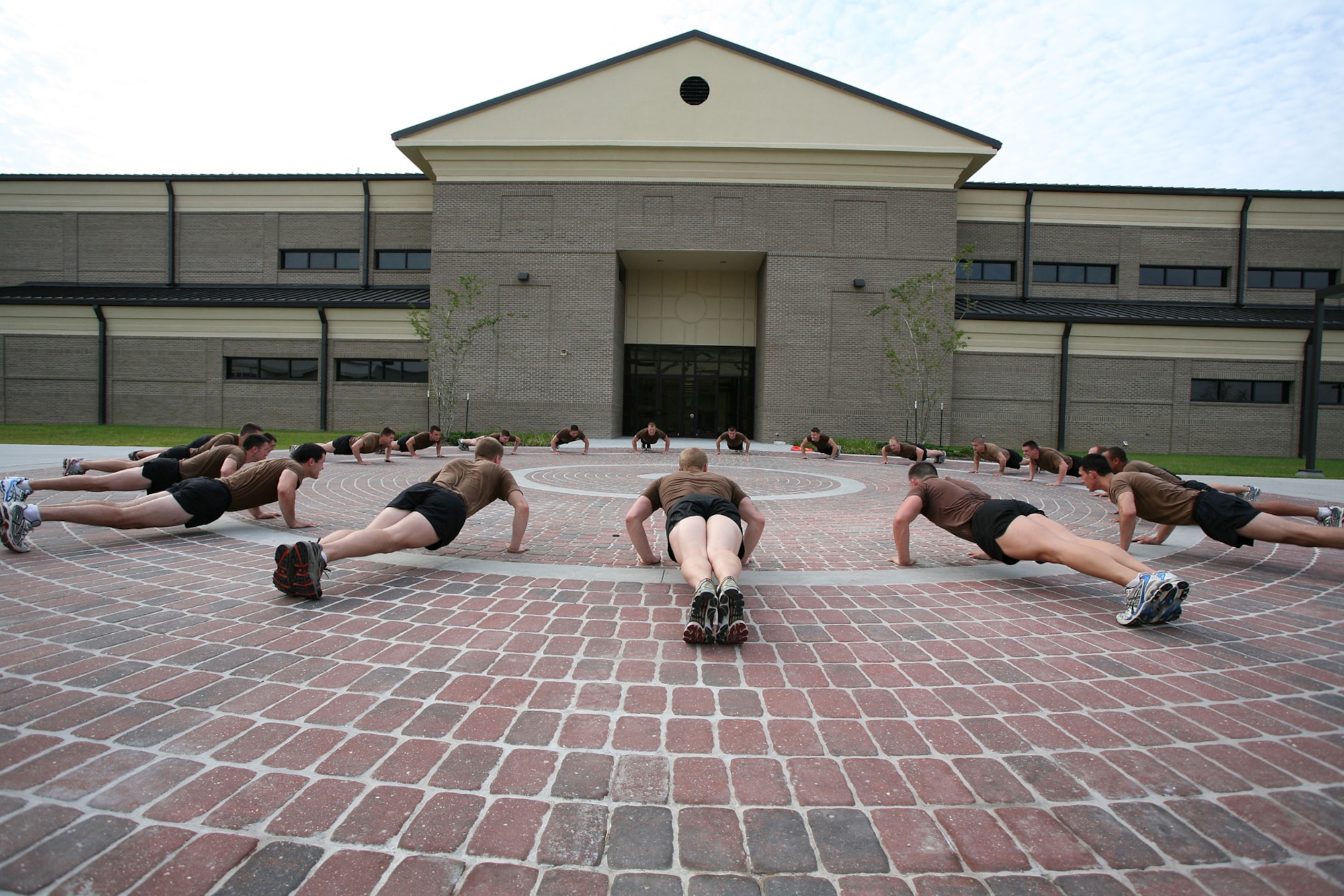 Combat control students do pushups in front of Matero Hall.  Keesler’s newest technical training facility is being dedicated today in memory of Tech. Sgt. Christopher Matero, who graduated from combat control training at Keesler 15 years ago.  Sergeant Matero and nine comrades died in 2002 when their MC-130H crashed into a mountainside 15 miles south of San Juan, Puerto Rico. 