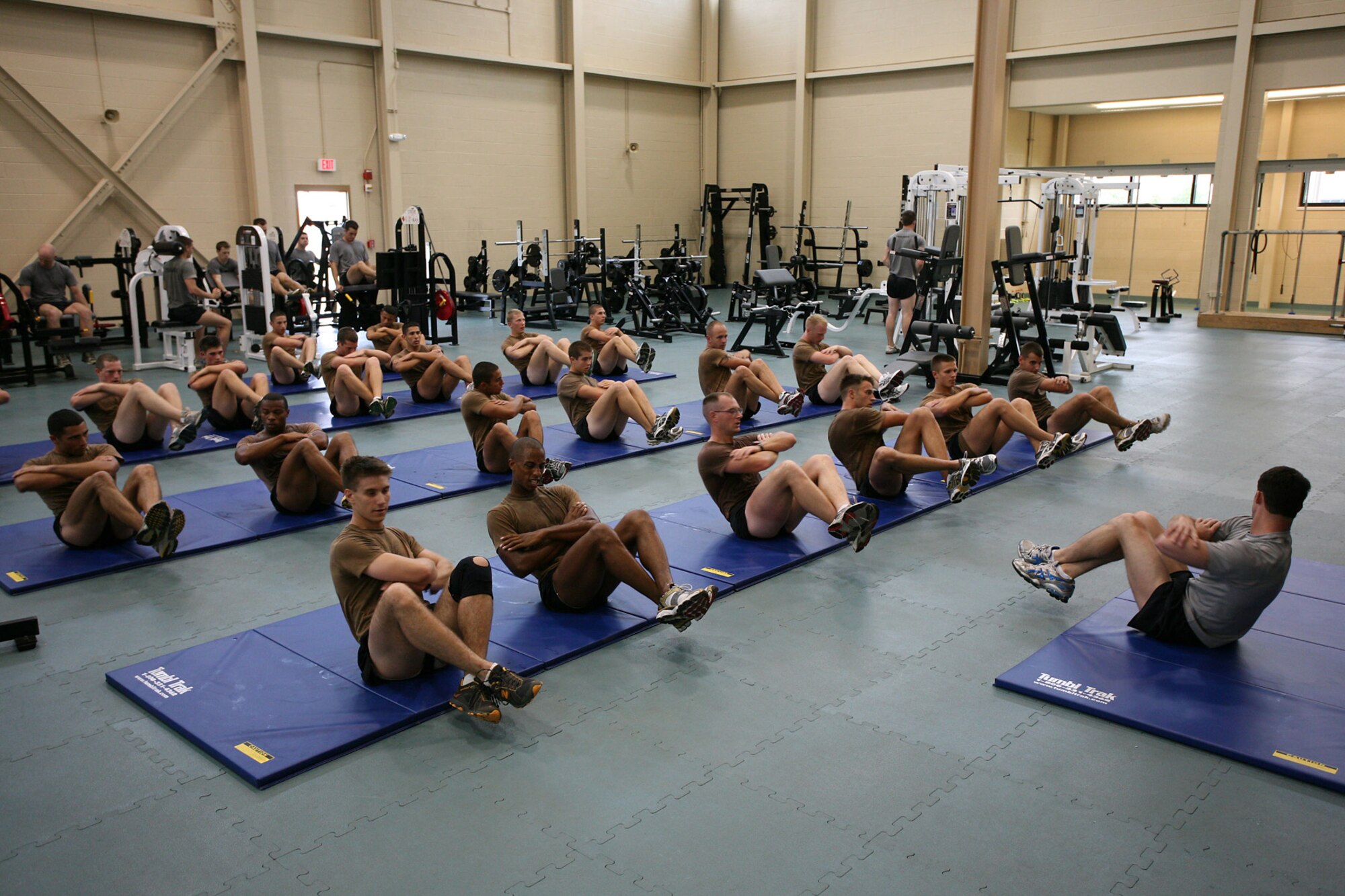 Combat control students do sit-ups during a workout session in Matero Hall.  (U.S. Air Force photo by Tech. Sgt. John Wylie)