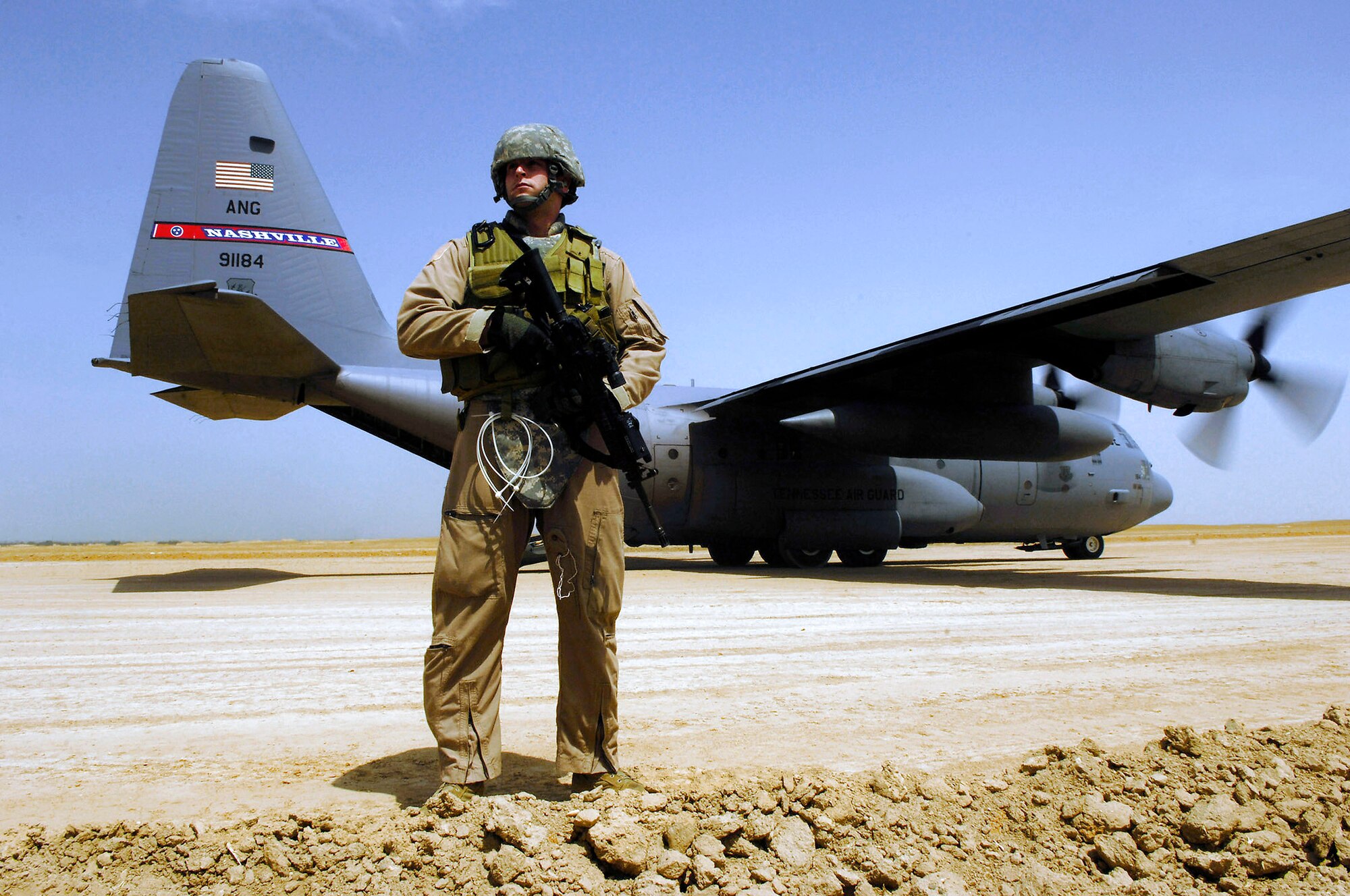 Senior Airman Matt Cooper provides security for a C-130 Hercules aircraft during a cargo mission in Afghanistan. Airman Cooper is part of a Fly Away Security Forces Team assigned to the 455th Expeditionary Security Forces and deployed from the 355th Security Forces Squadron, Davis-Monthan Air Force Base, Ariz. The C-130 is the prime transport for air dropping troops and equipment into hostile areas. (U.S. Air Force photo/Master Sgt. Andy Dunaway) 
