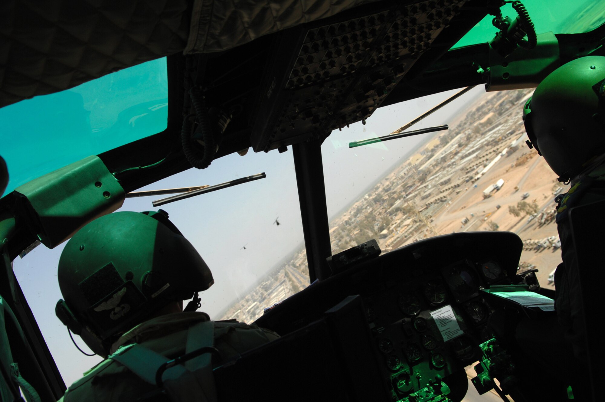 BALAD AIR BASE, Iraq -- Capt. Dave Albin, Multinational Security Transition Command-Iraq pilot (left), escorts OH-58 Kiowas as they are flown by Iraqi pilots from here to Camp Taji April 25. A total of 10 Kiowas will be used at Camp Taji to conduct training for Iraqi Air Force pilots. Captain Albin is deployed from F.E. Warren, Wyo. (U.S. Air Force photo/ Senior Airman Julianne Showalter)