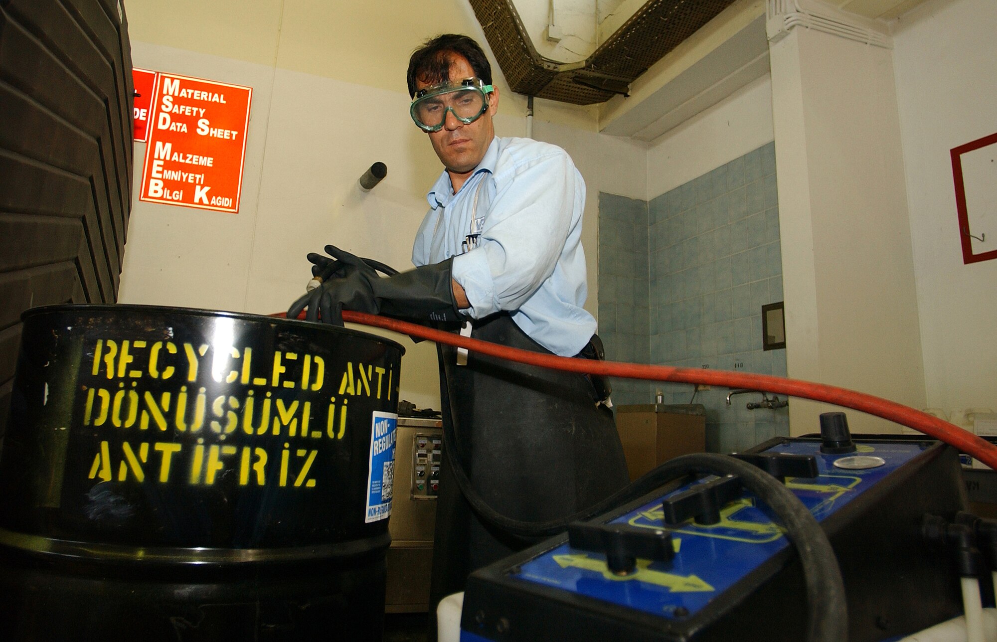 Yilmaz Eroglu, 39th Logistics Readiness Squadron, moves recycled coolant from the anti-freeze recycler to a 55 gallon drum. This recycler is one of many initiatives the 39 LRS has taken to save the Air Force thousands of dollars each month. (U.S. Air Force photo by Airman 1st Class Benjamin Wilson)